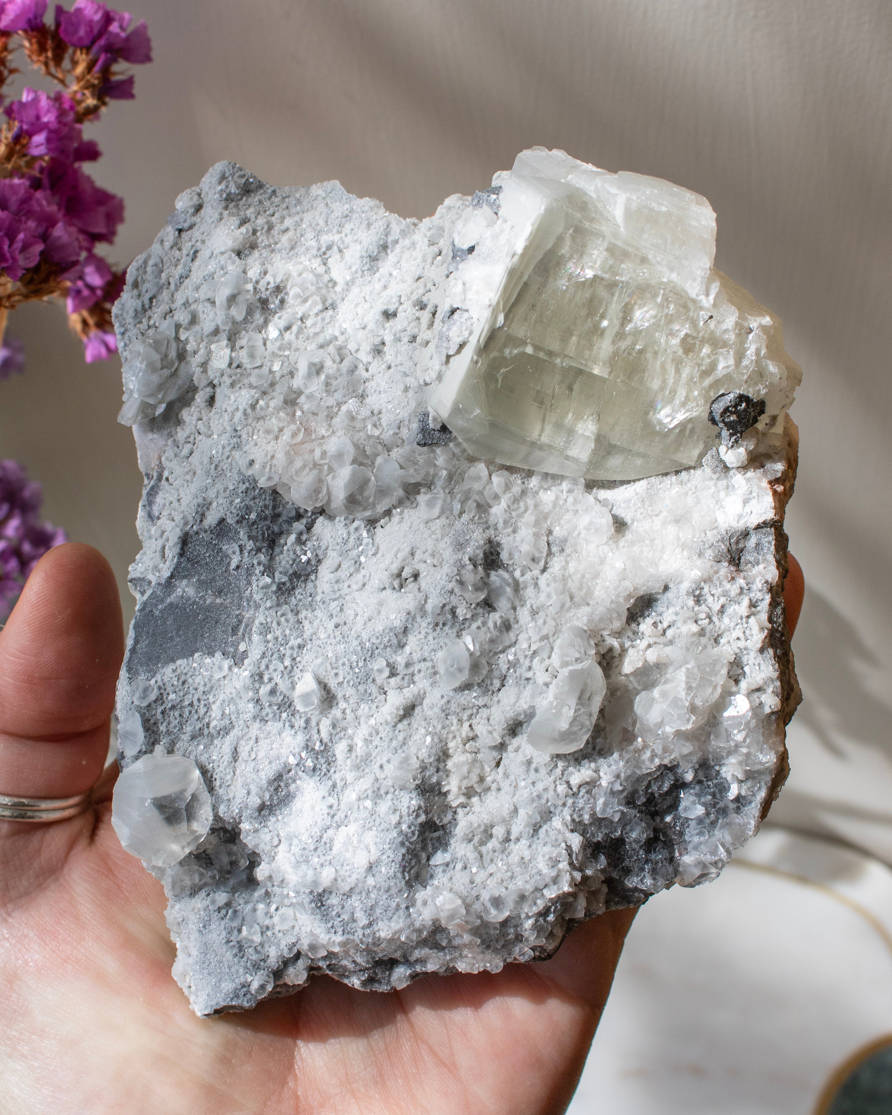 Crystal rock held in a hand with a blurred background