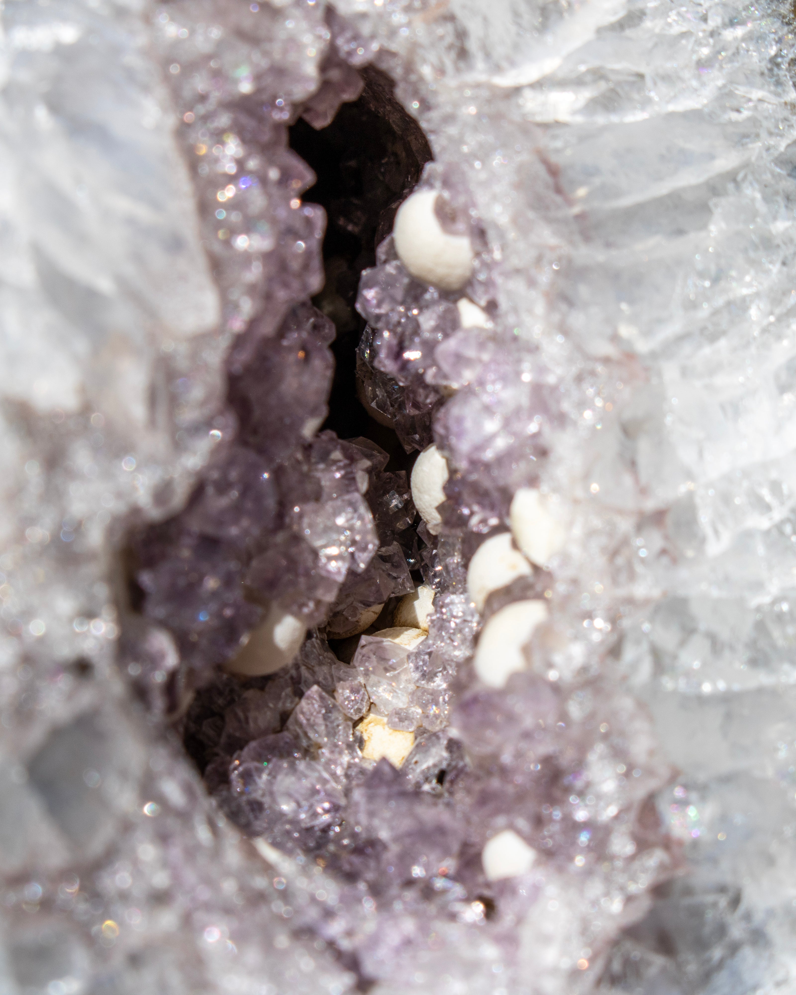 Close-up of a crystal formation with a central cavity filled with smaller crystals.