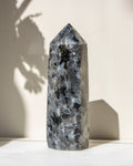 Decorative crystal tower on a white surface with a neutral background