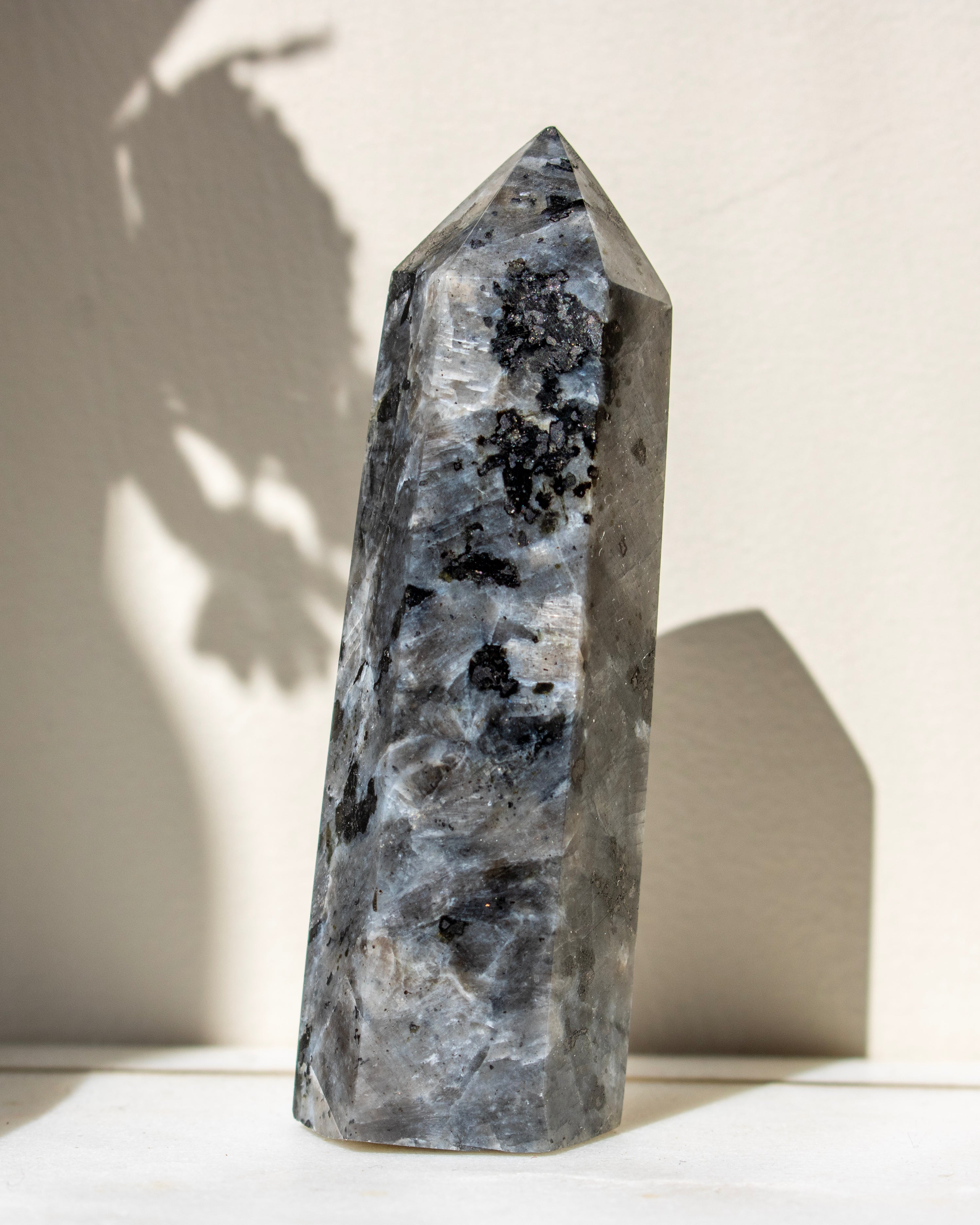Decorative stone tower with a textured surface on a light background