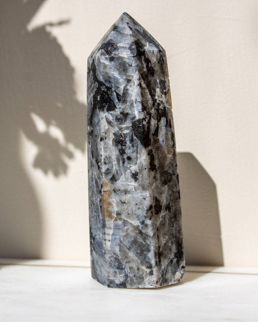 Decorative crystal tower on a light surface with a neutral background