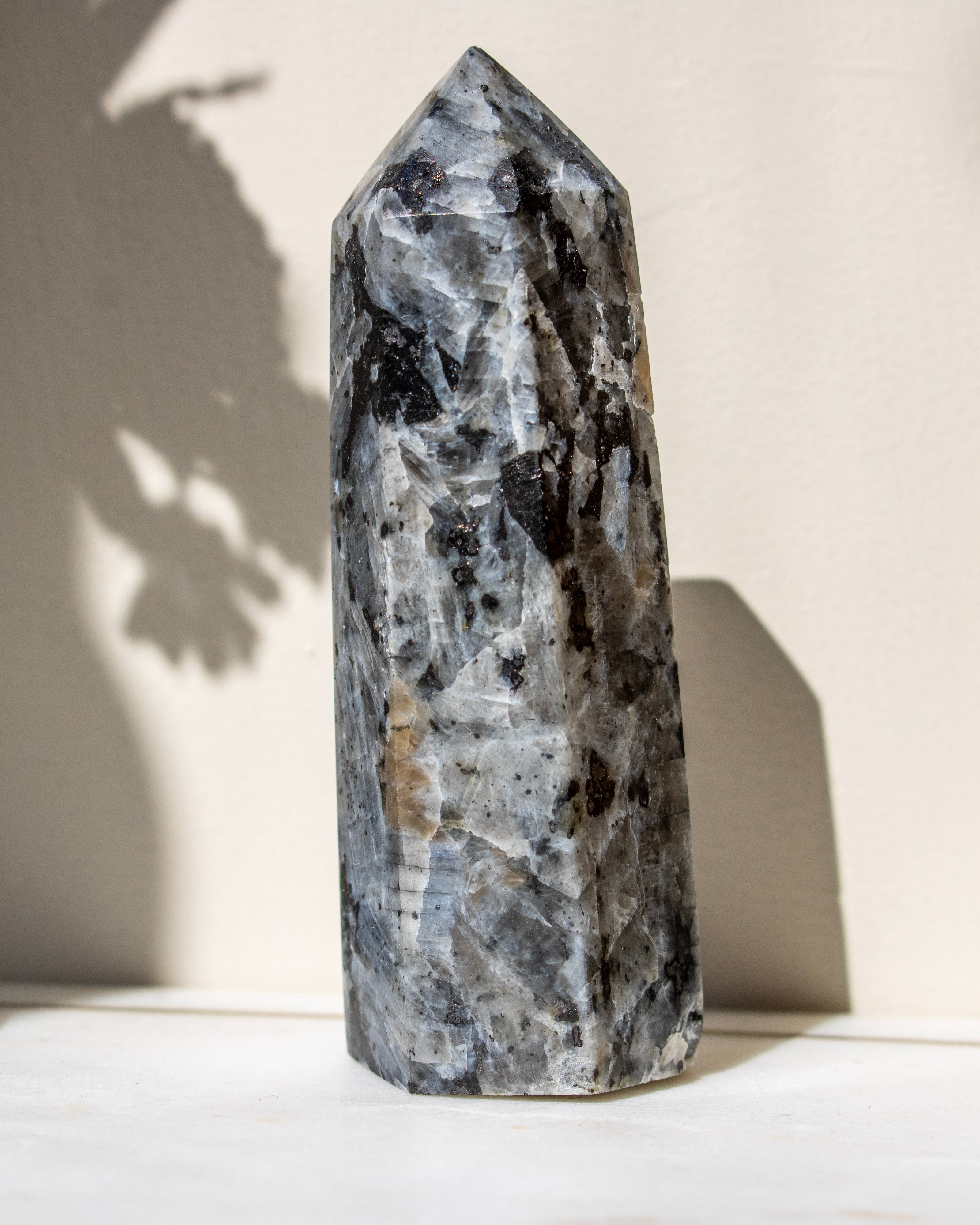 Decorative crystal tower on a light surface with a neutral background