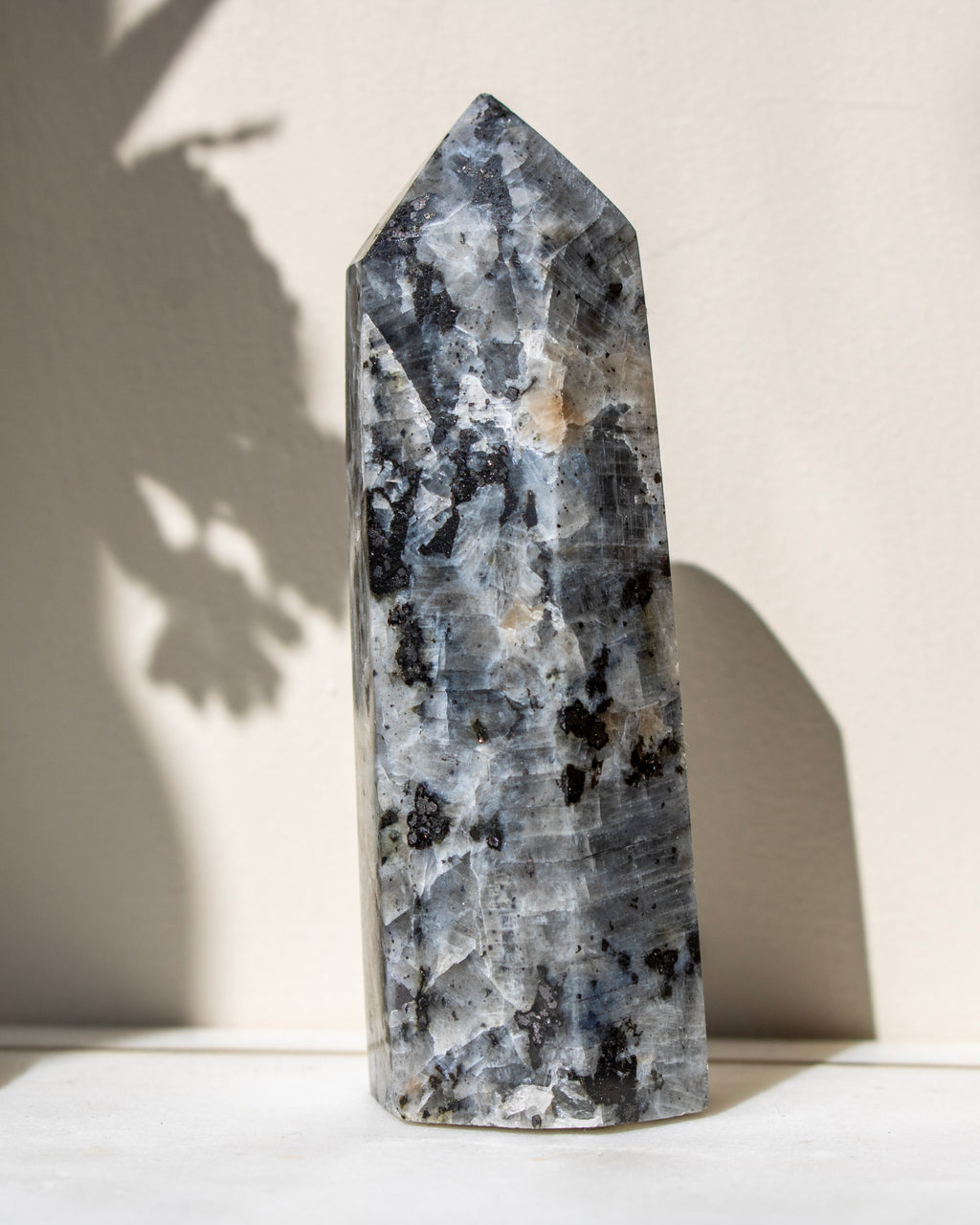 Decorative crystal tower with black and white patterns on a light background
