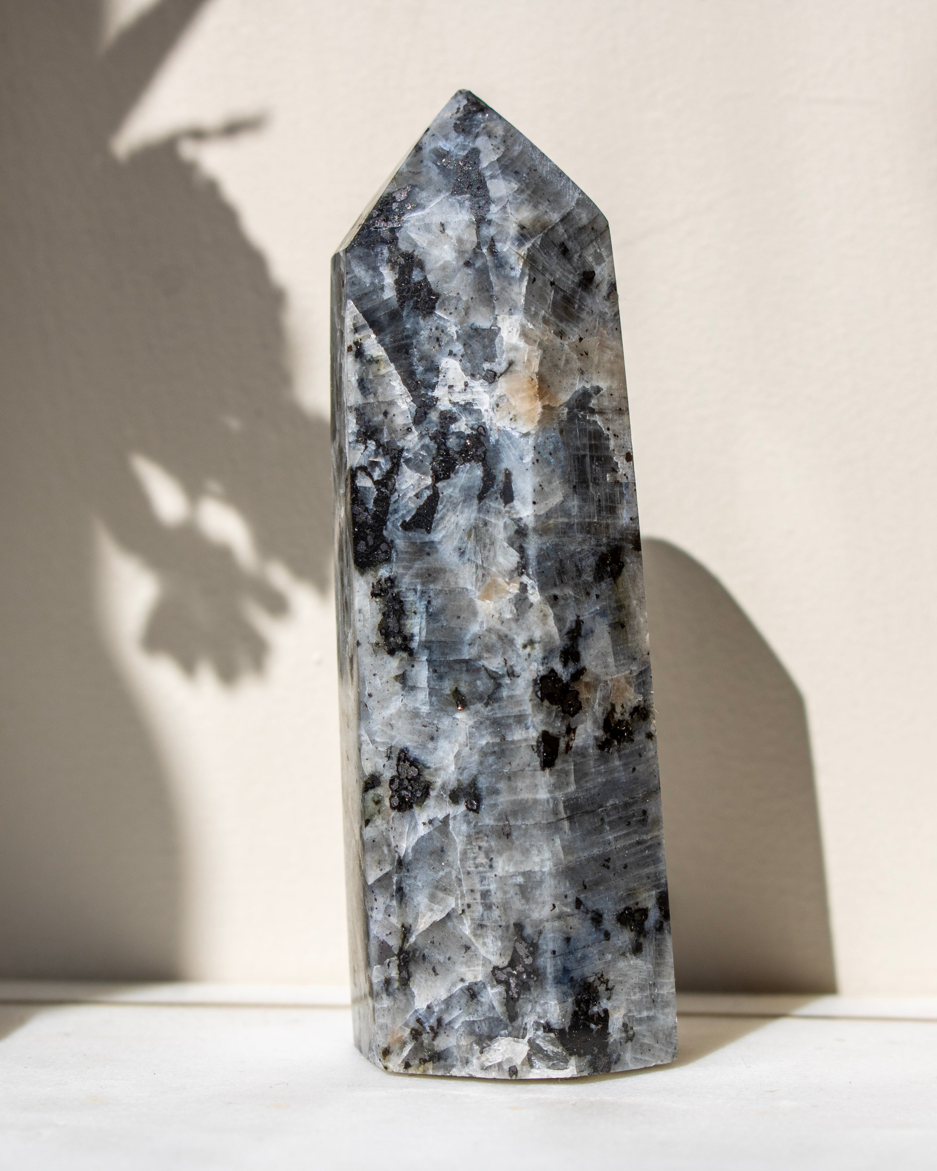 Decorative crystal tower with black and white patterns on a light background