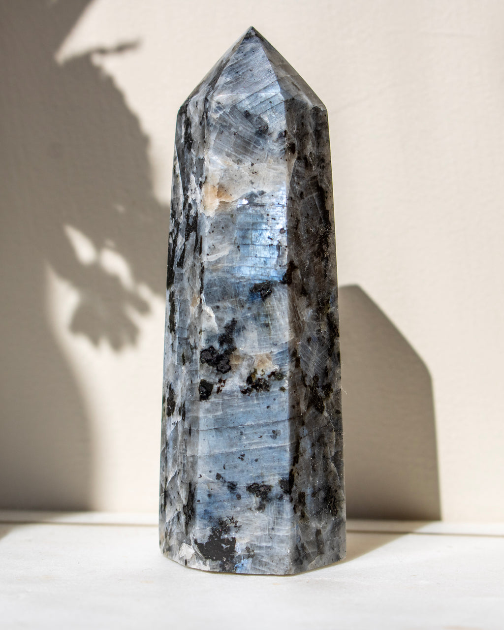 Crystal tower with a natural pattern on a white surface