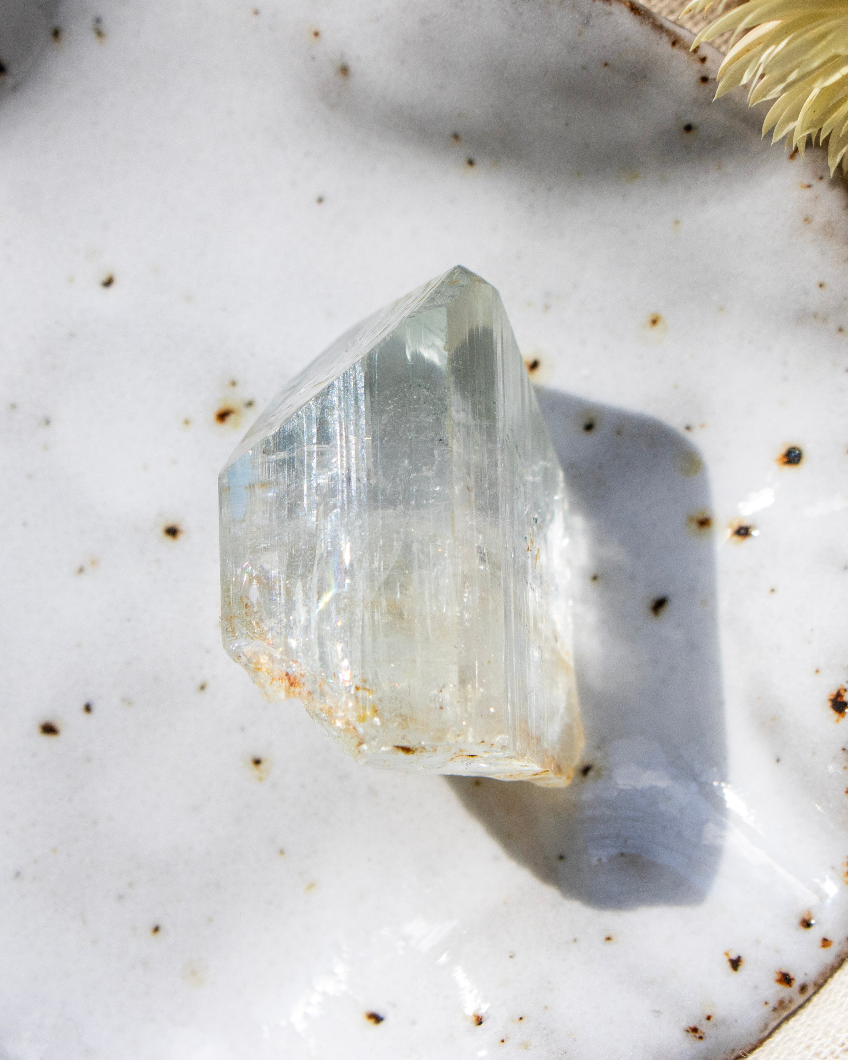 Clear crystal on a textured white surface