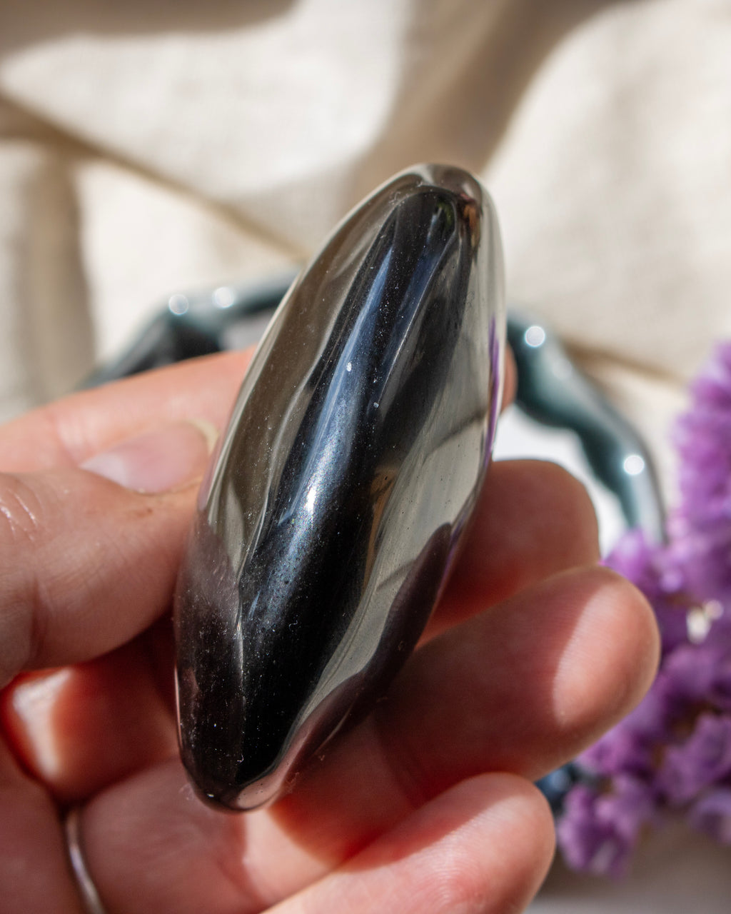 a black stone being held in a hand