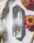 Crystal on a textured surface with pink flowers