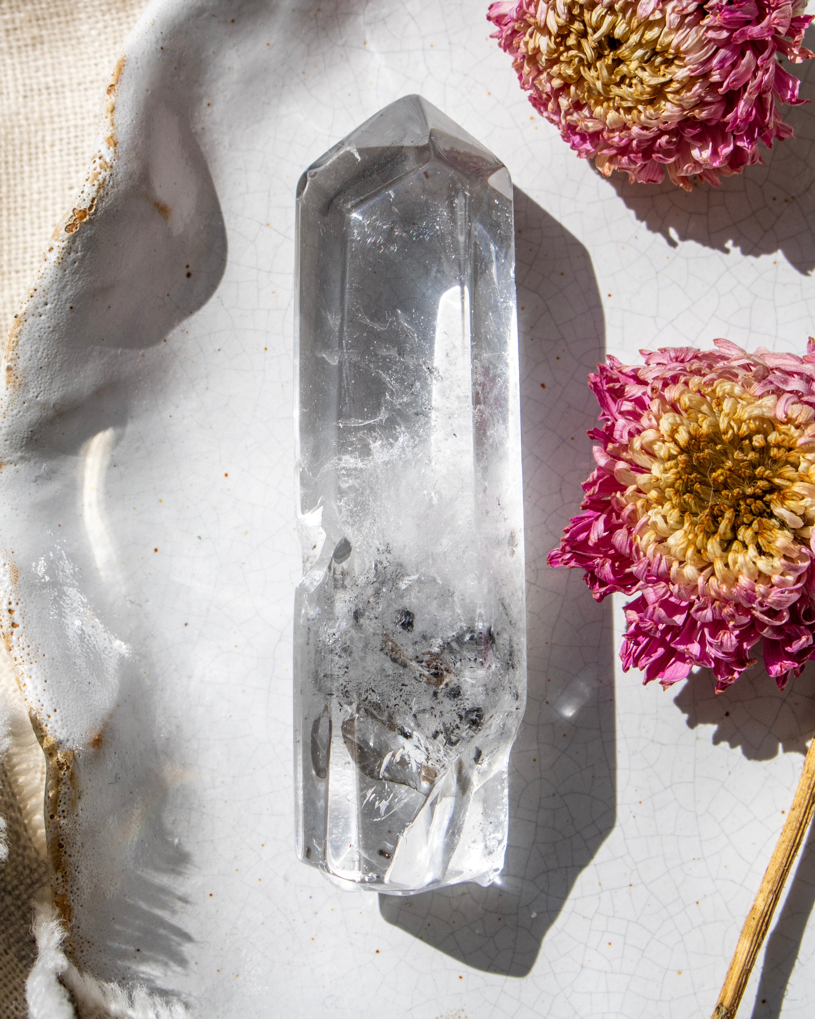 Crystal on a textured surface with pink flowers