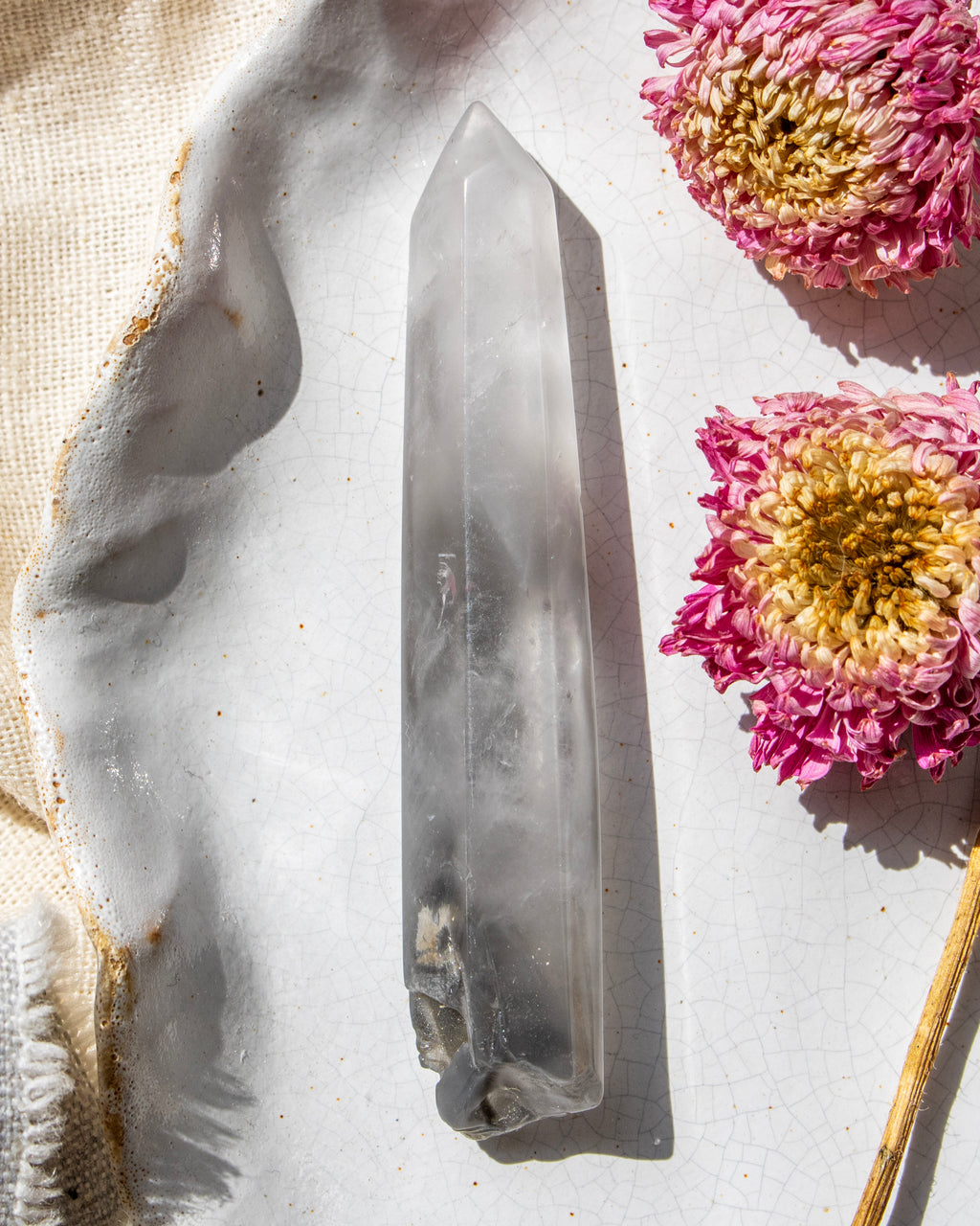 Crystal on a light surface with pink flowers