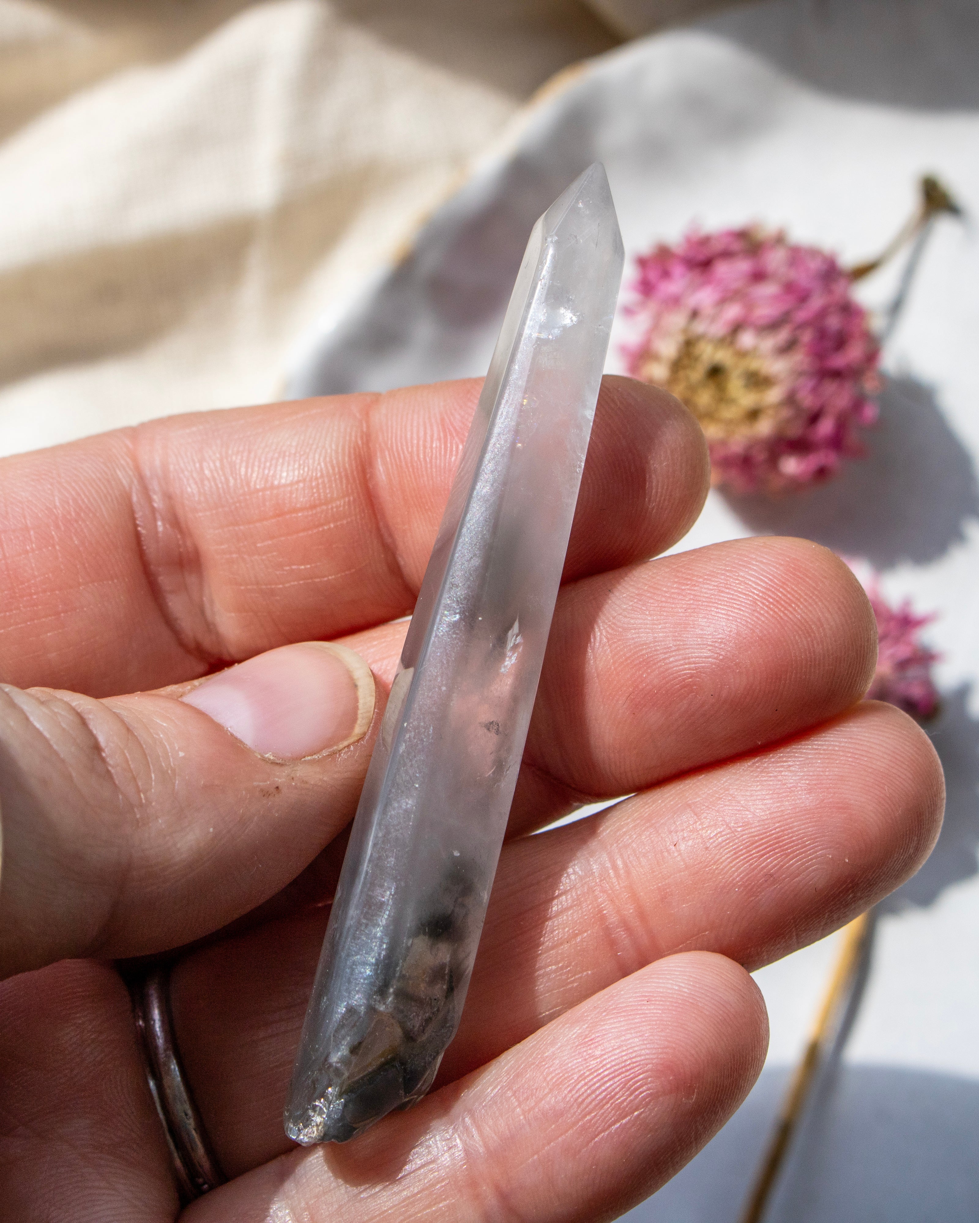 a clear crystal being held with a blurred background