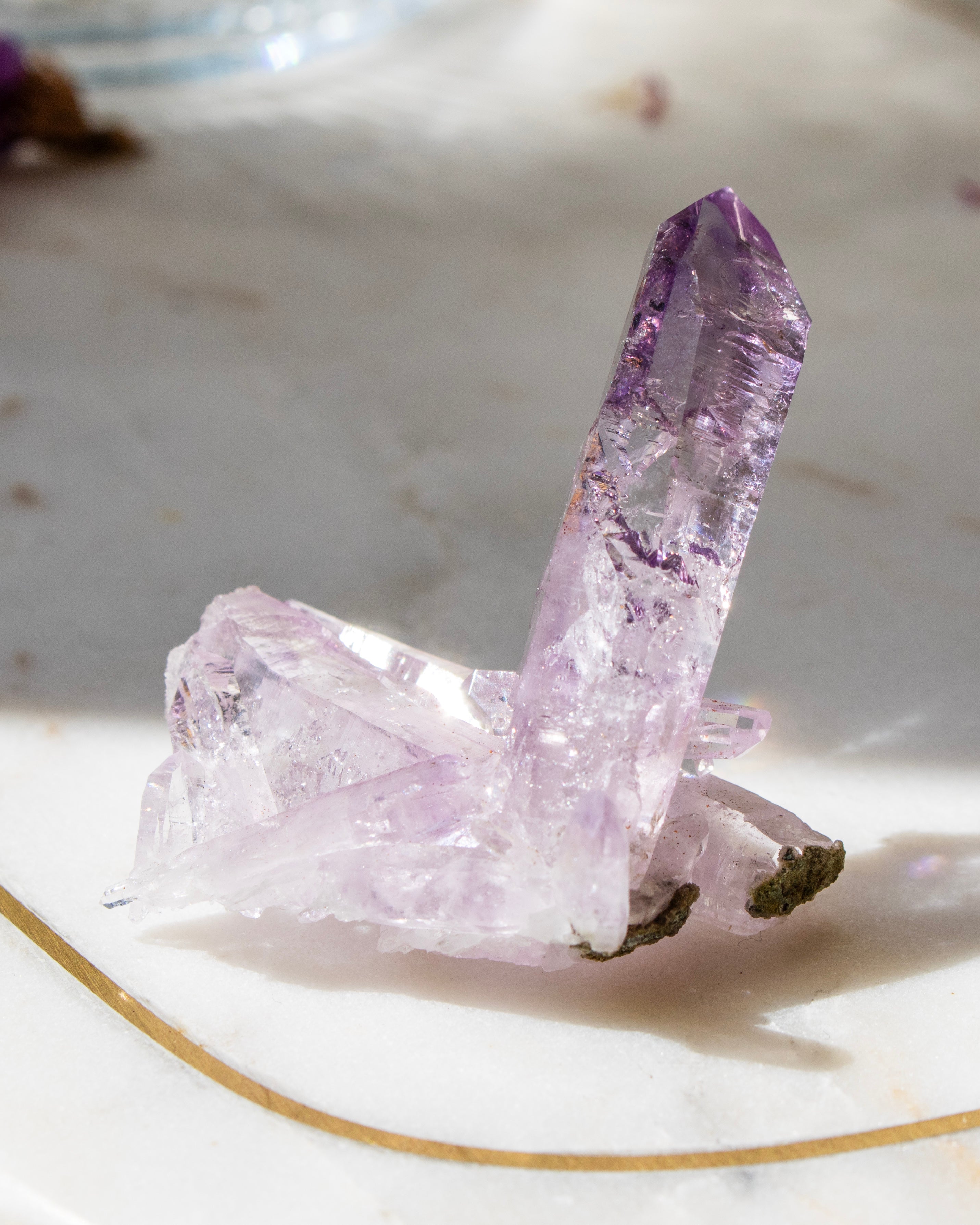 Amethyst crystal on a white surface