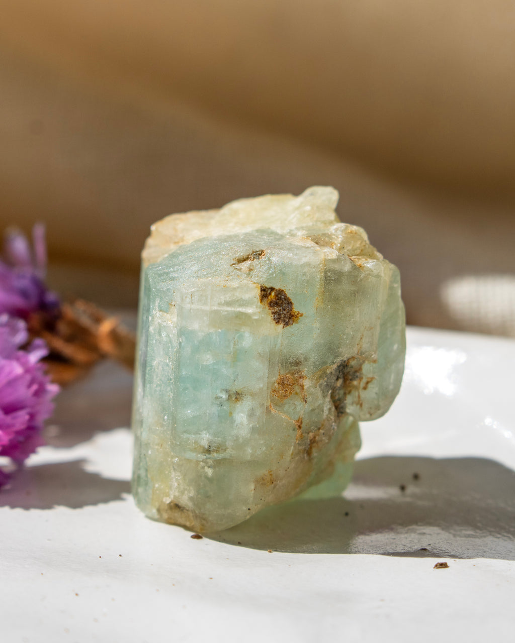 Crystal rock with natural texture on a white surface with blurred background
