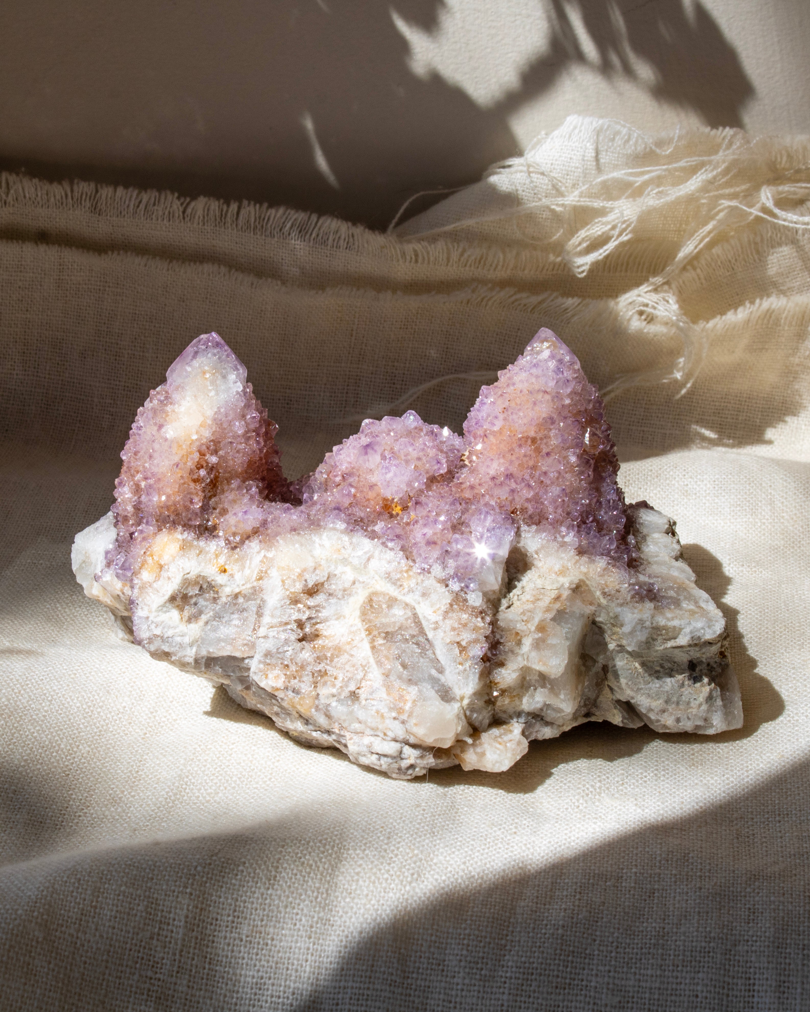 spirit quartz crystal formation on a white fabric background