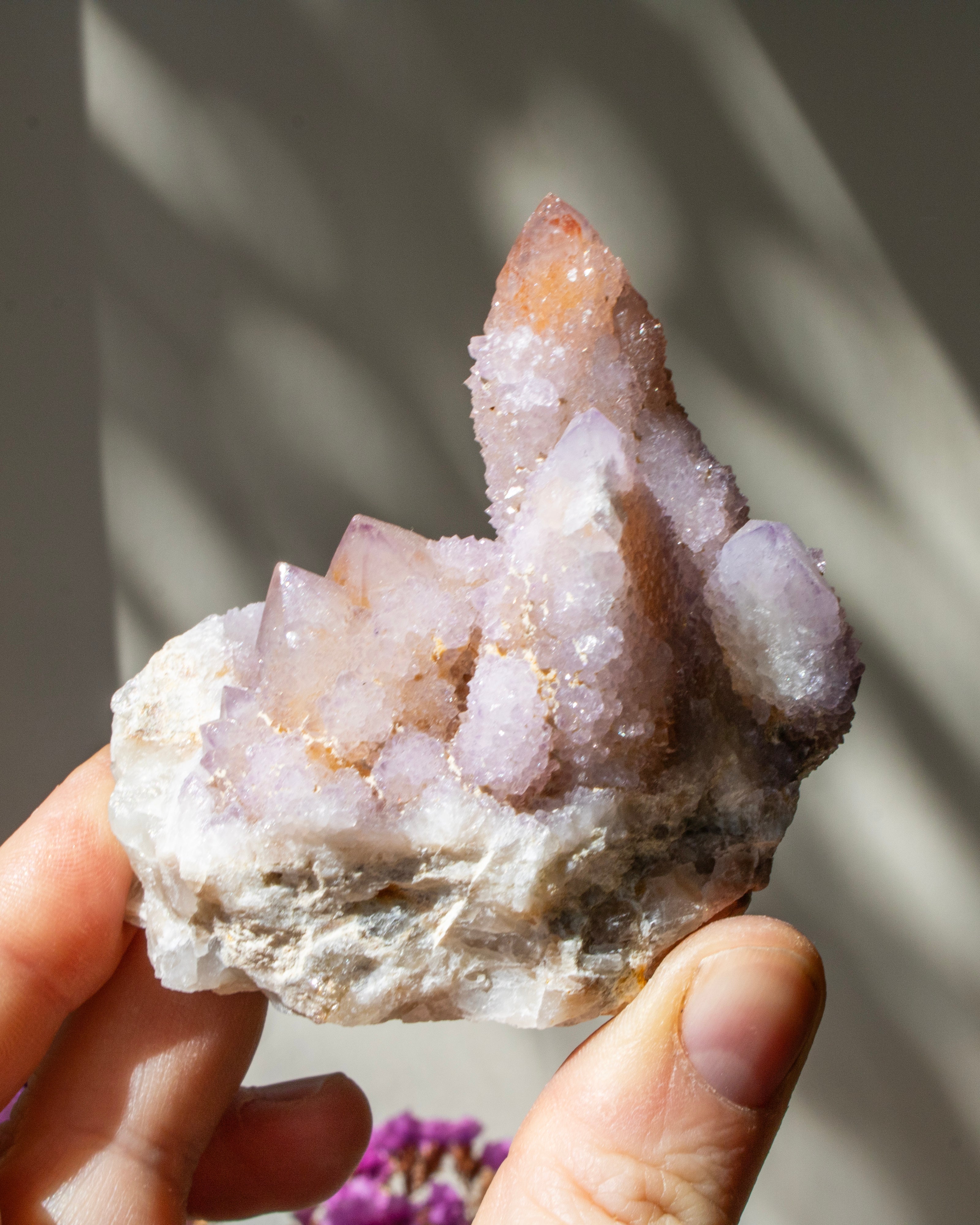 Hand holding a crystal formation with a blurred background