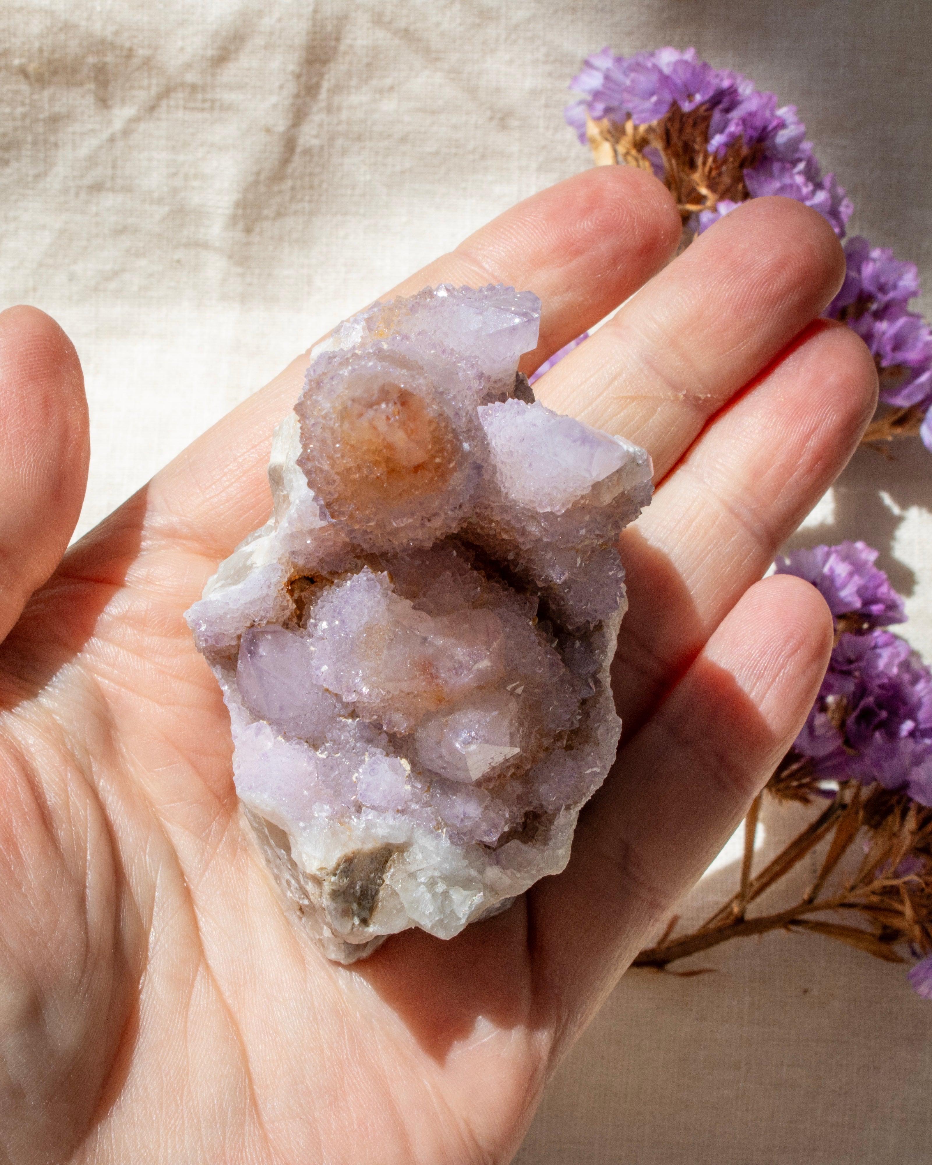 Hand holding a crystal formation with a blurred background