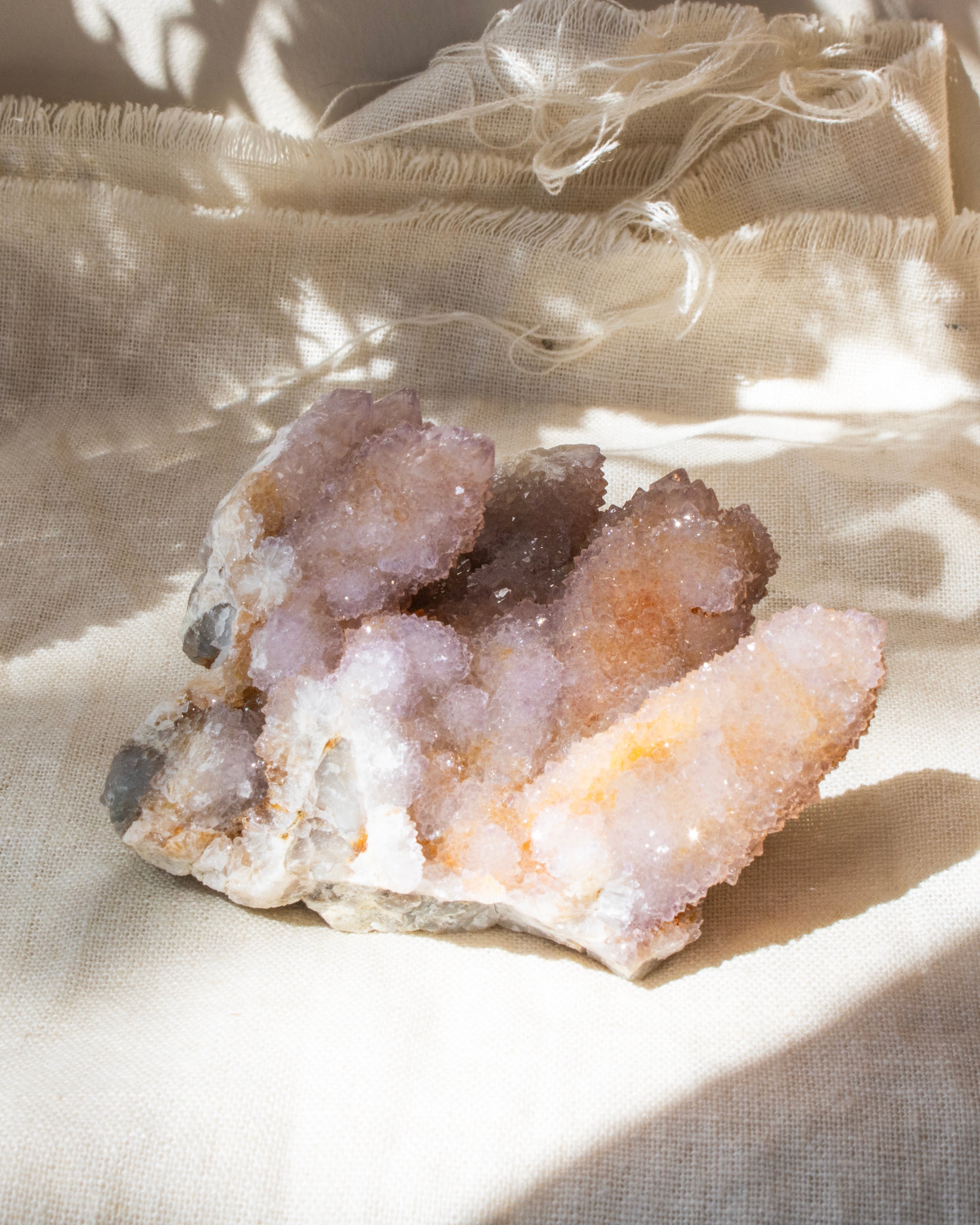 crystal cluster on a beige textured fabric