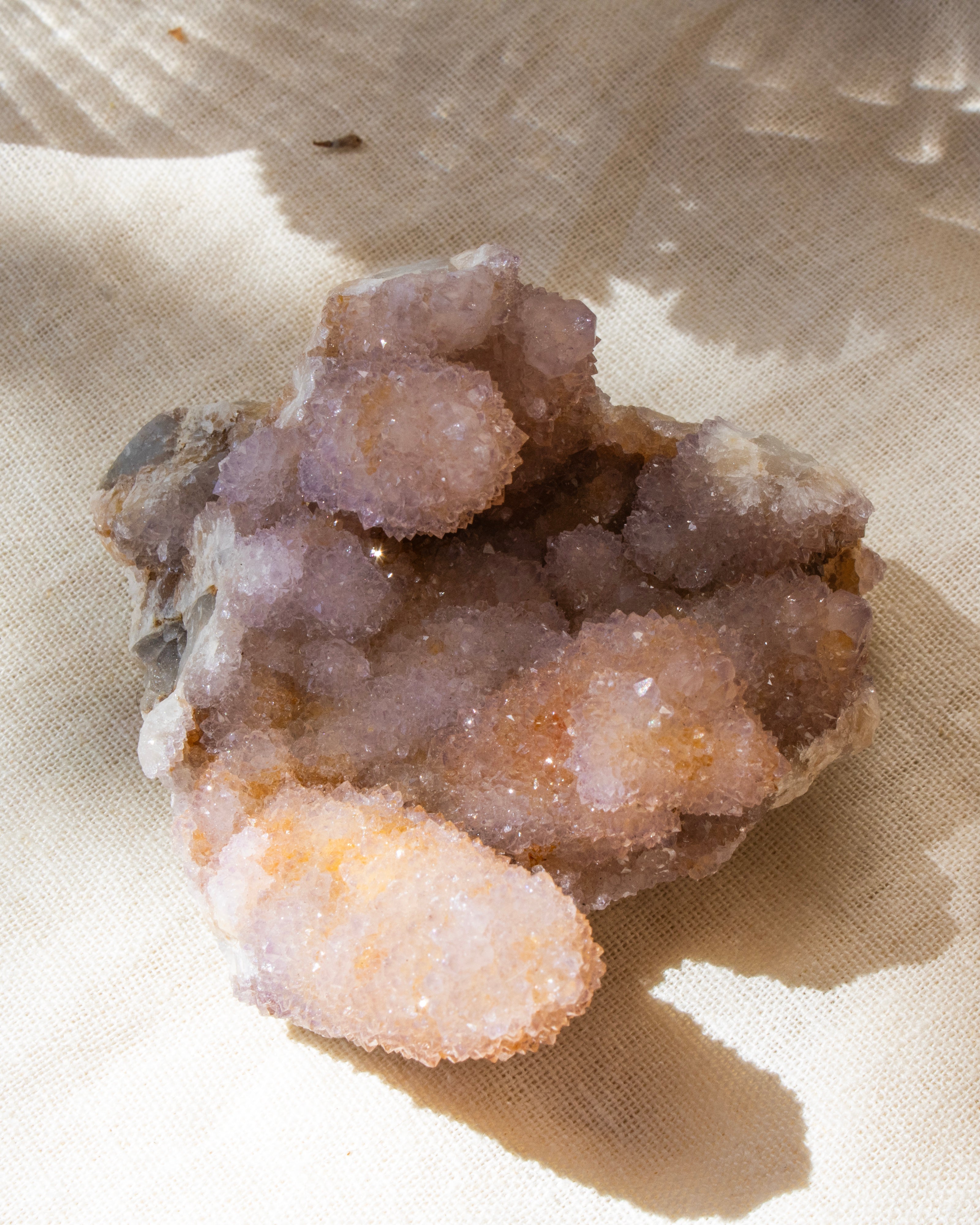 crystal cluster on a beige textured fabric