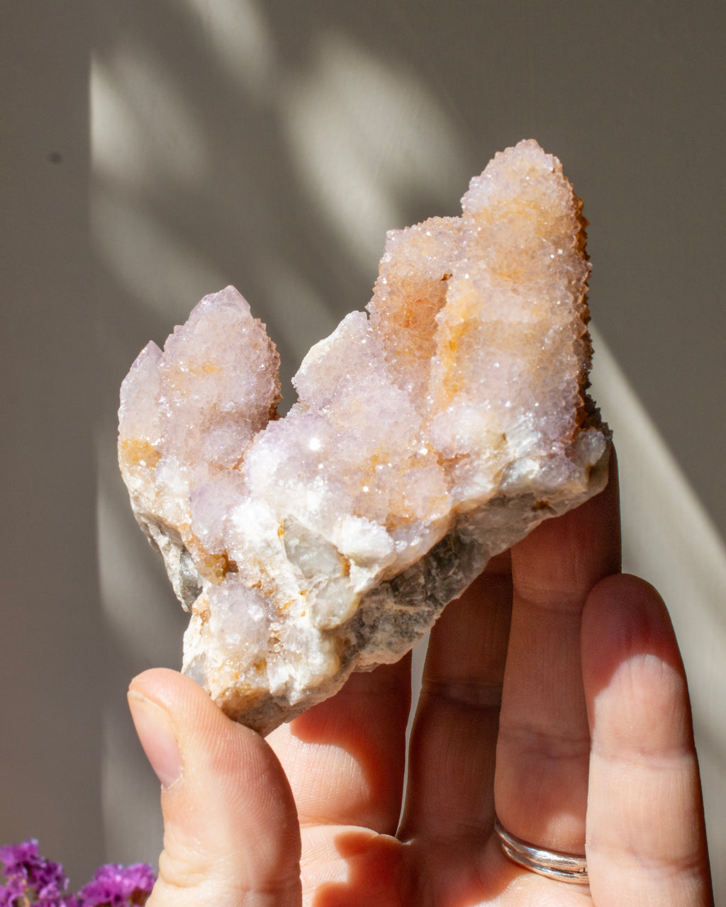 Hand holding a crystal rock with a blurred background