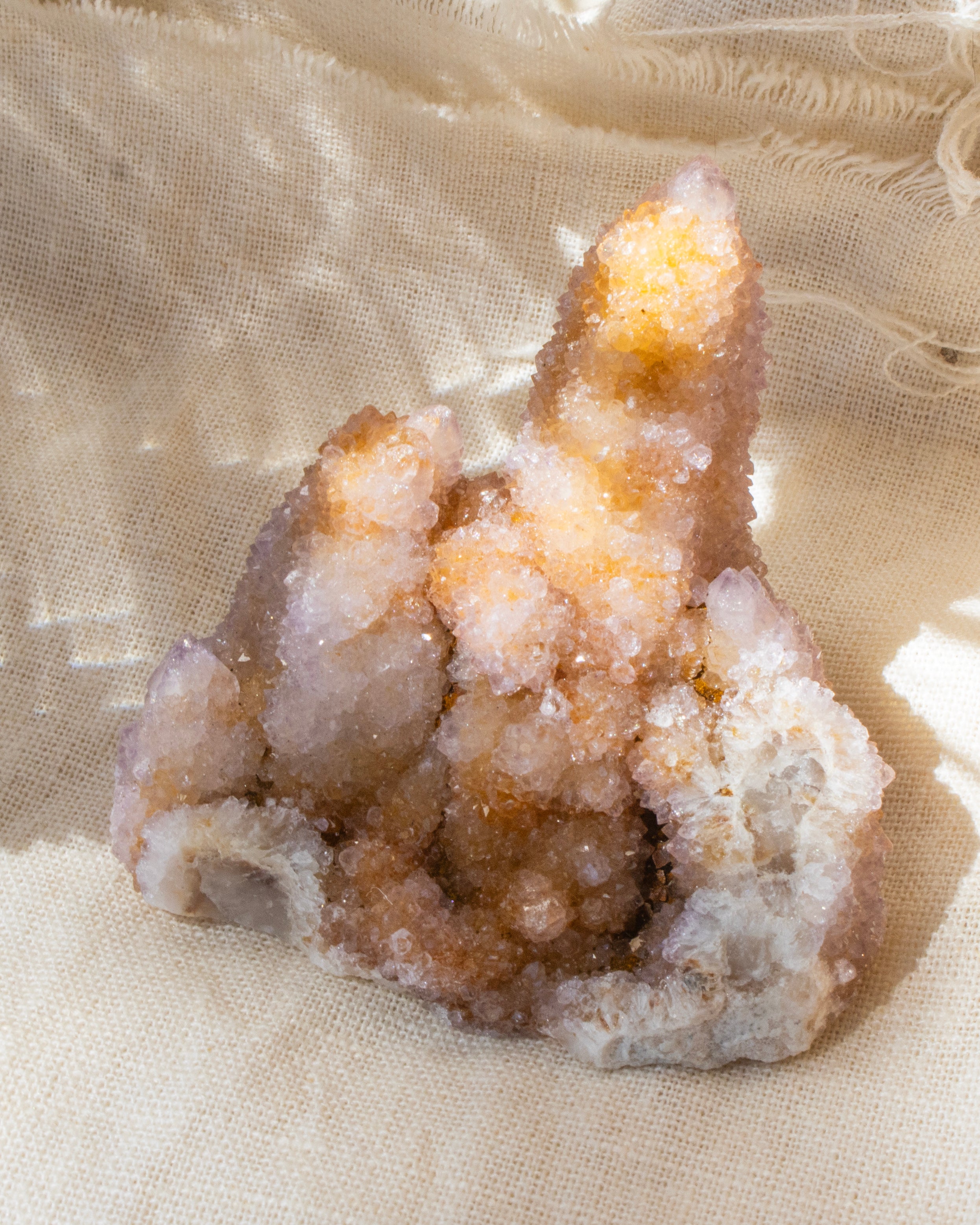 Geode crystal on a beige fabric background