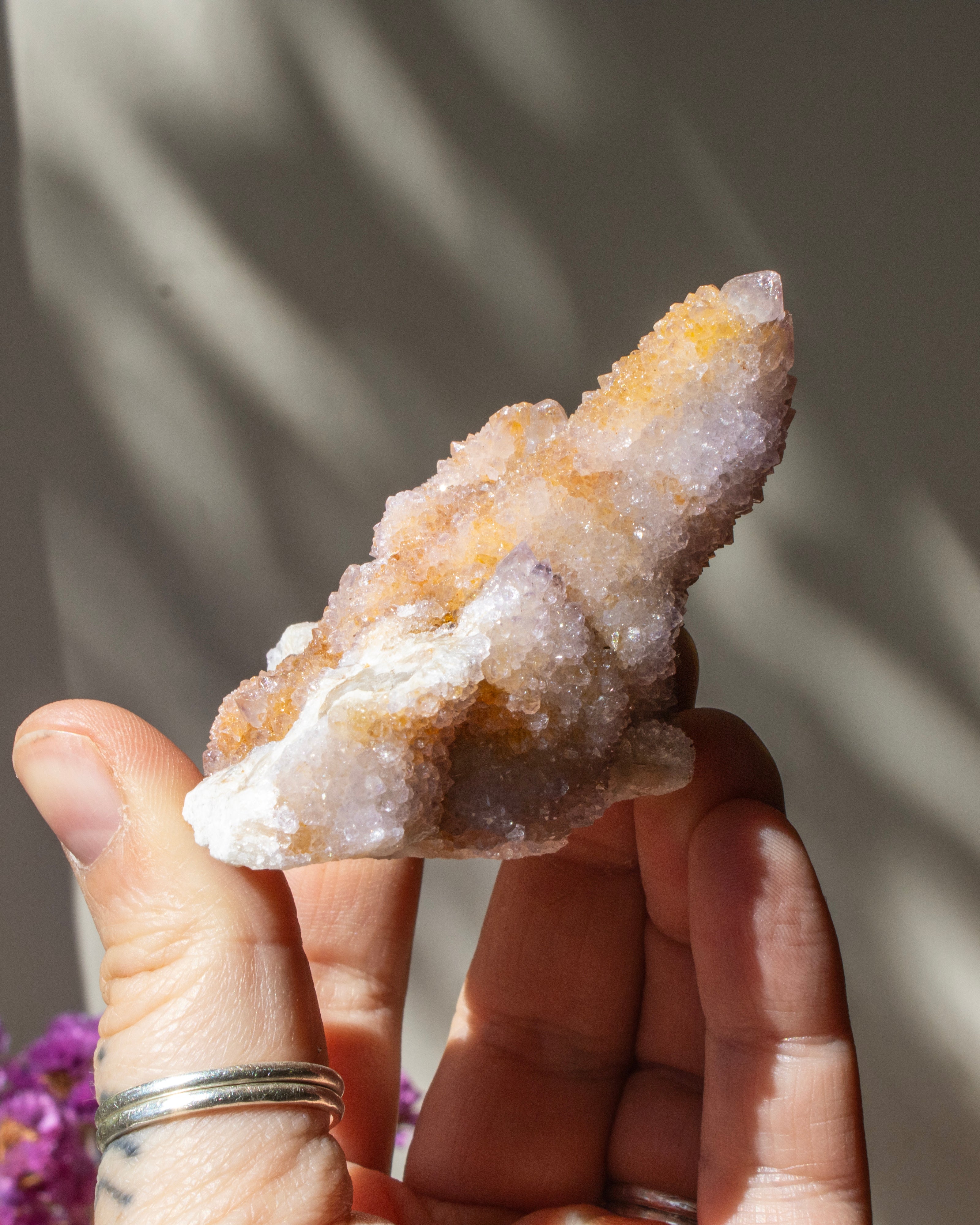 Hand holding a large crystal with a blurred background