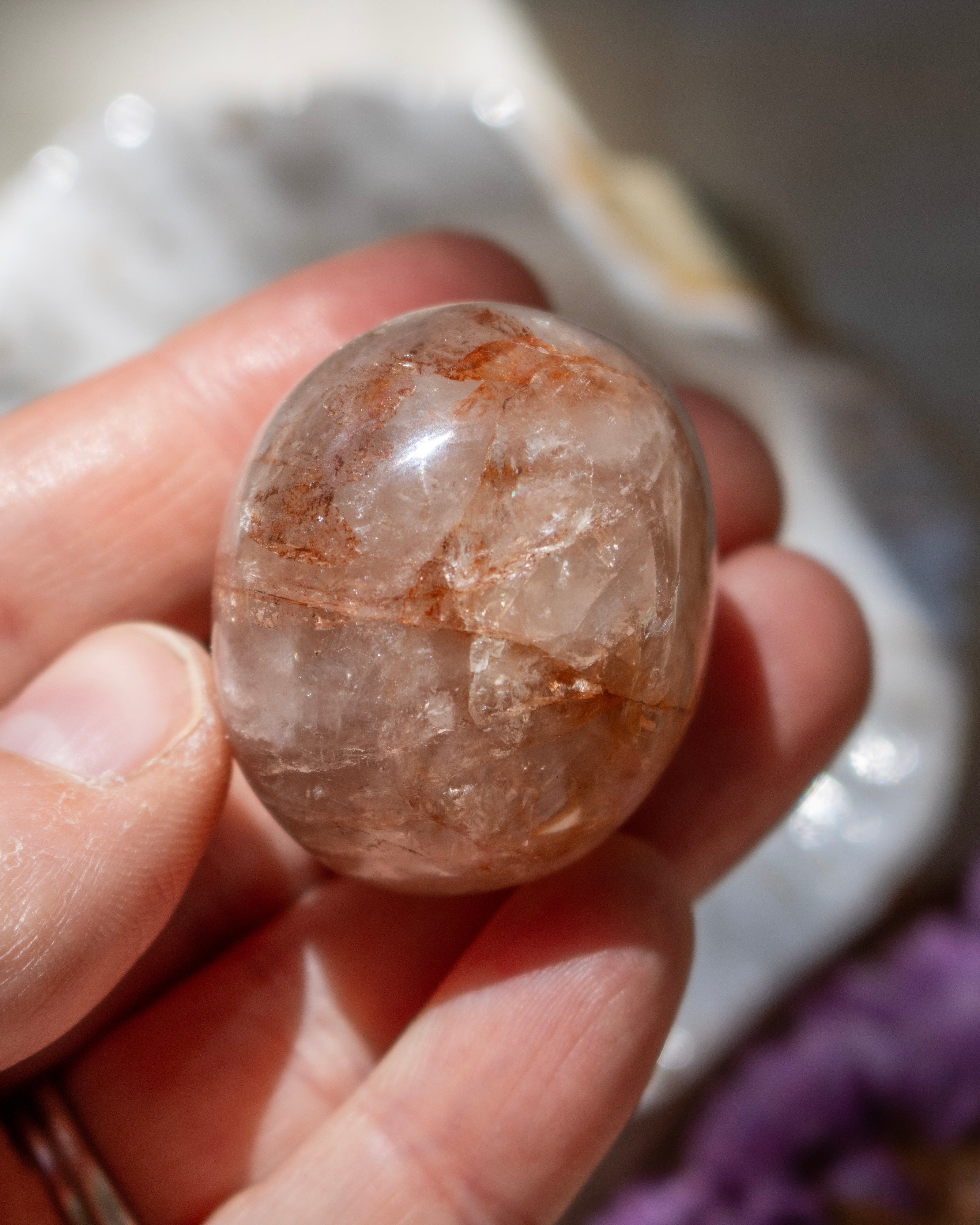 Crystal held in a hand with a blurred background