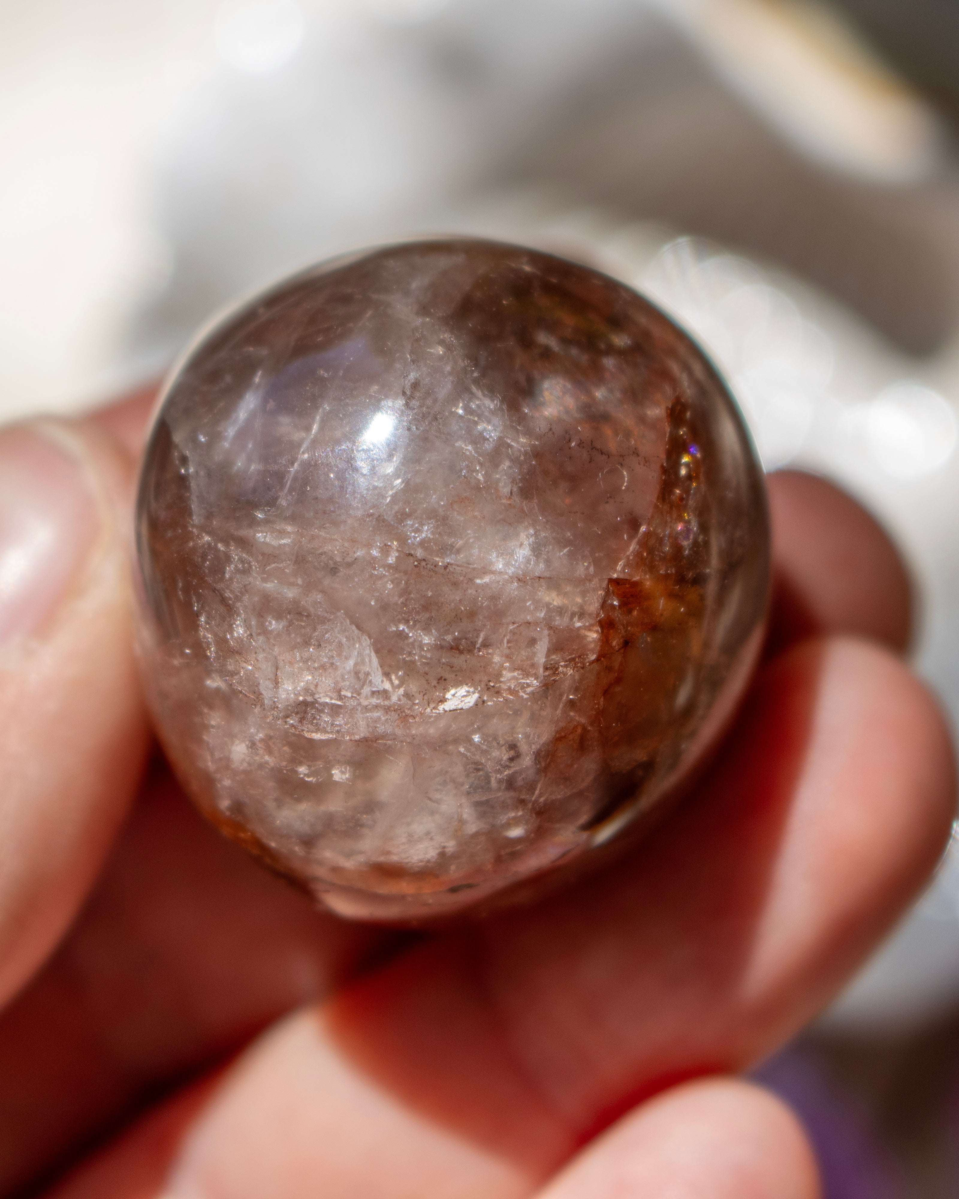 Crystal ball held in a hand with a blurred background