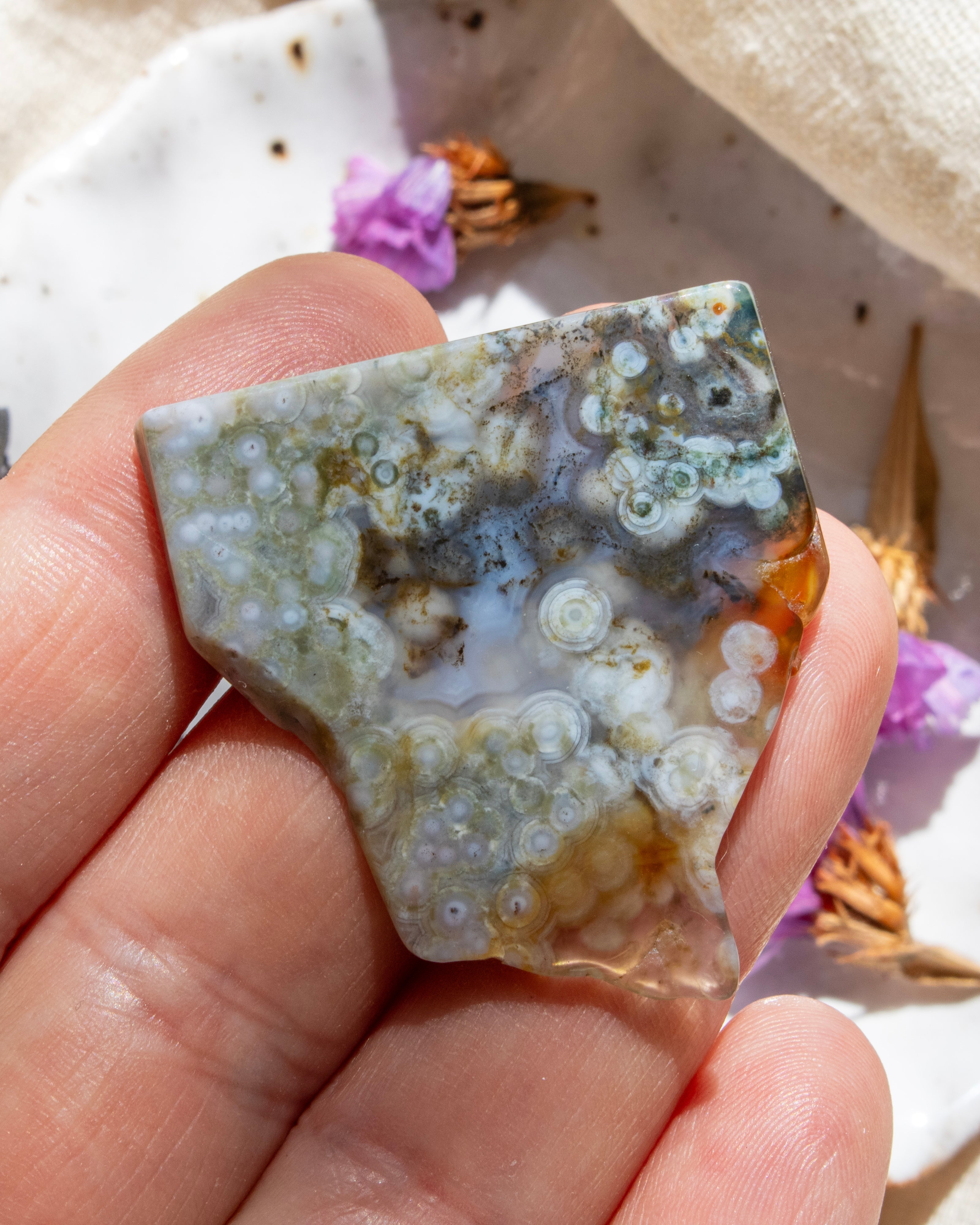 Hand holding a piece of agate with a textured surface