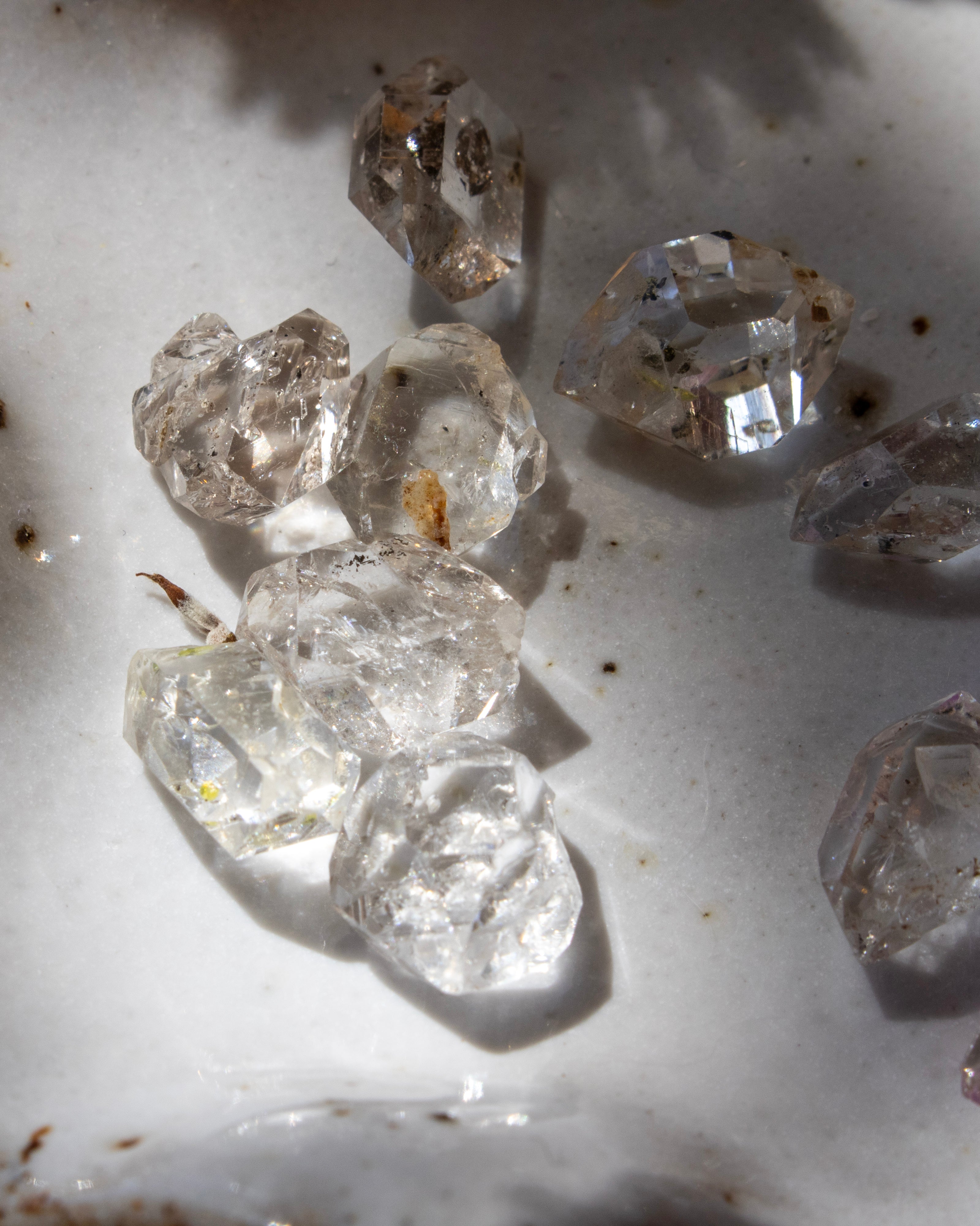 Raw diamonds on a white surface
