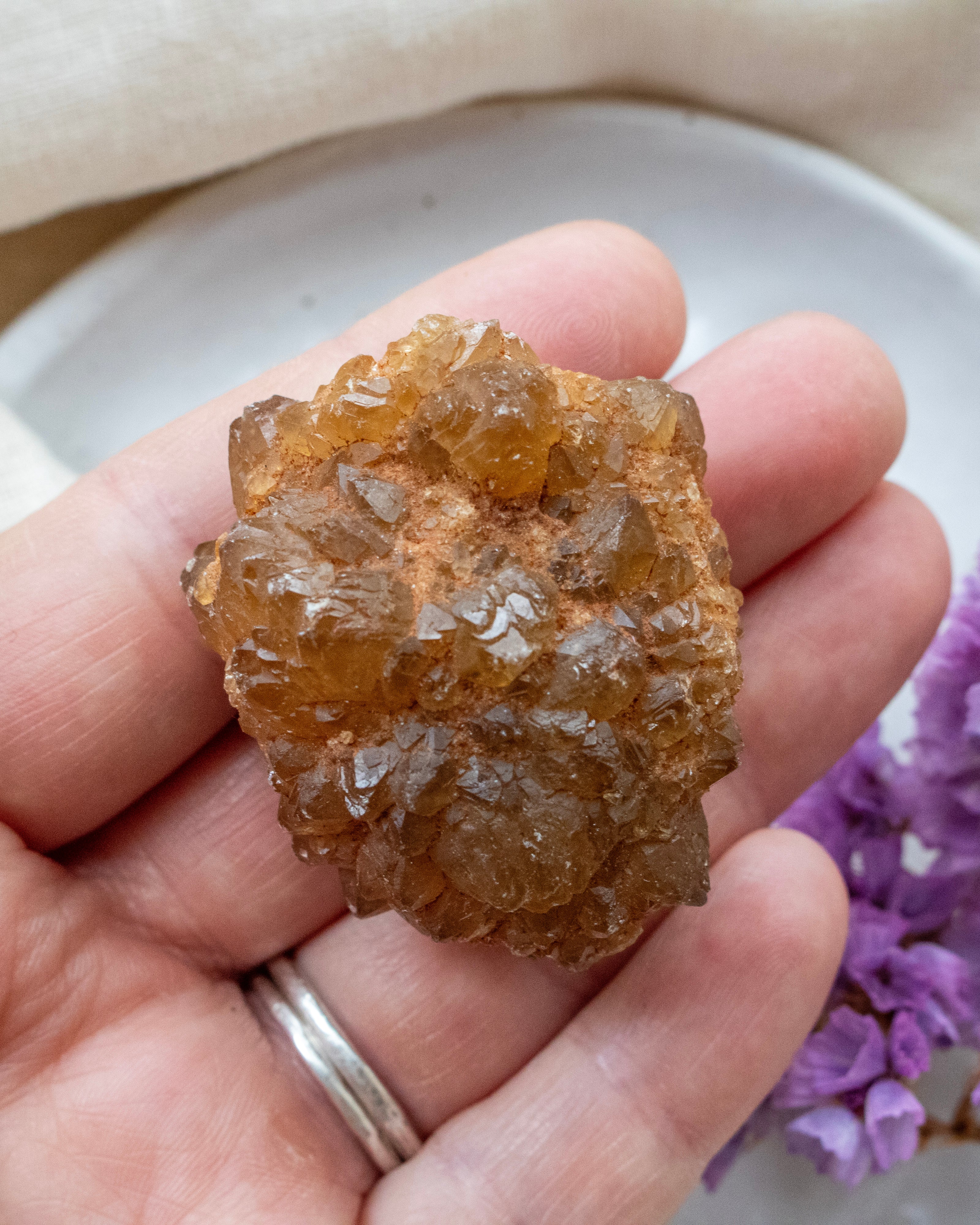 Hand holding a large crystal with a blurred background