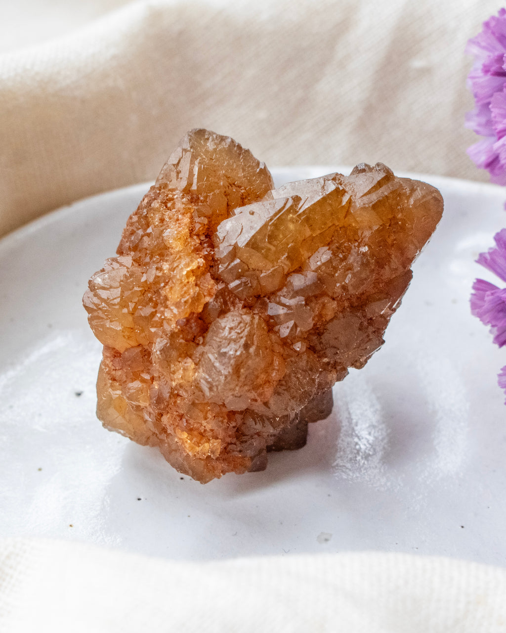 Brown crystal on a white surface with a blurred background