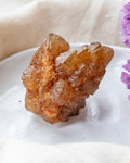 Brown crystal on a white surface with a blurred background