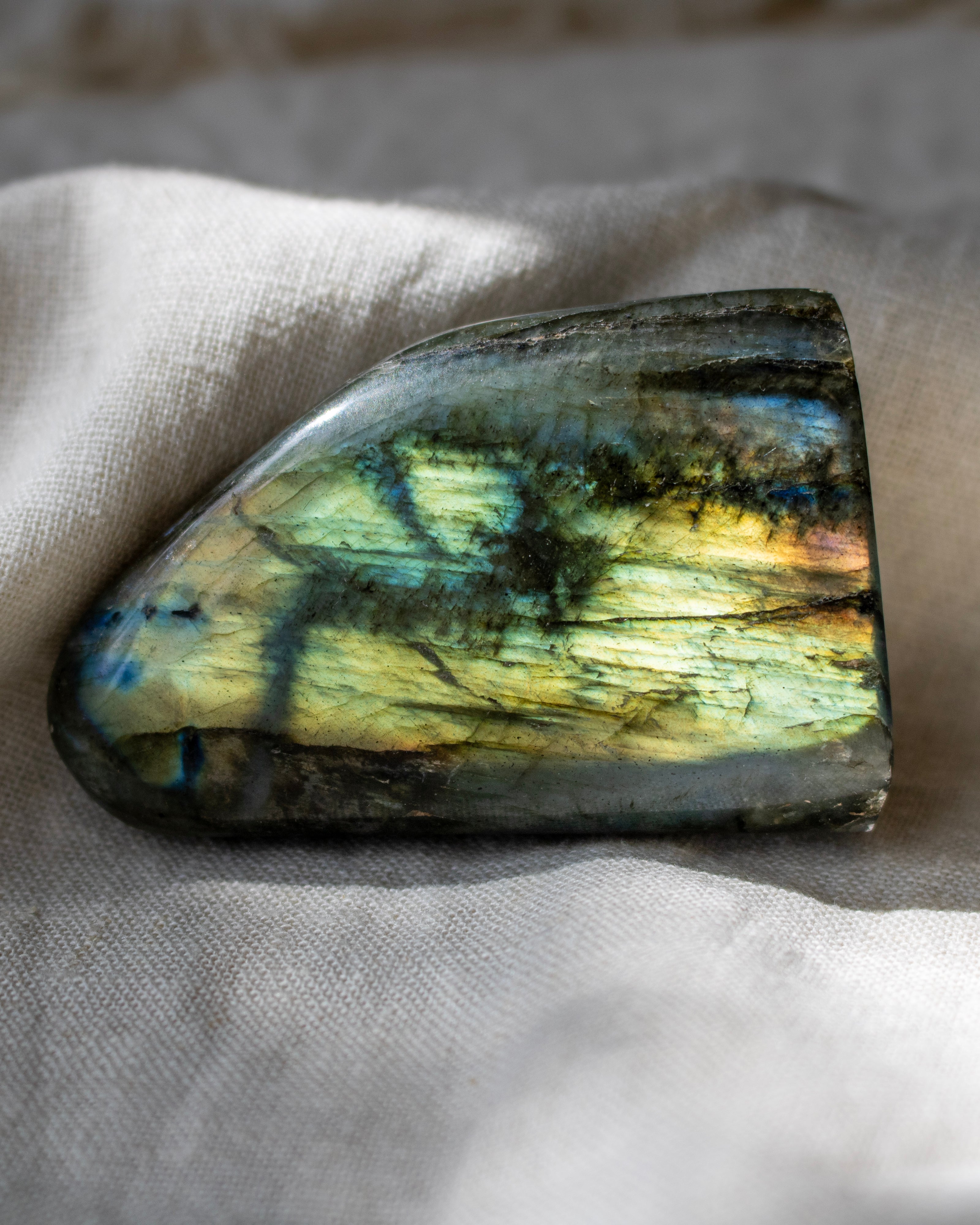 Labradorite stone on a textured fabric background