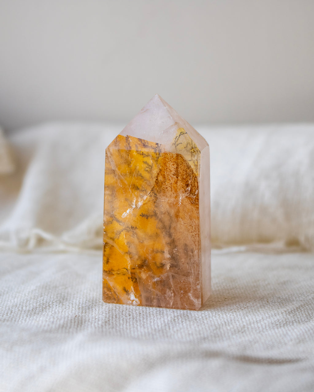 Crystal tower with yellow and white patterns on a white fabric background