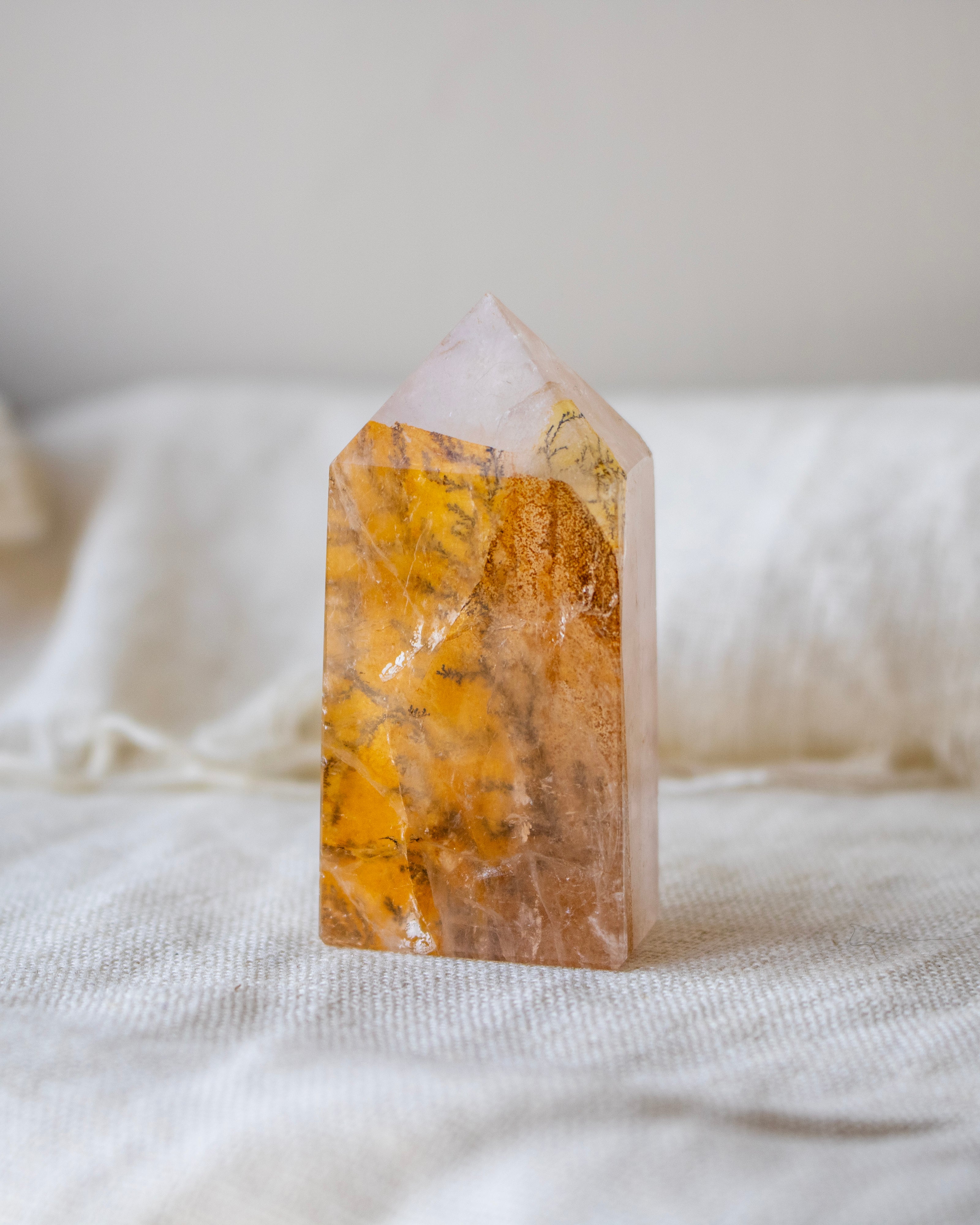 Crystal tower with yellow and white patterns on a white fabric background