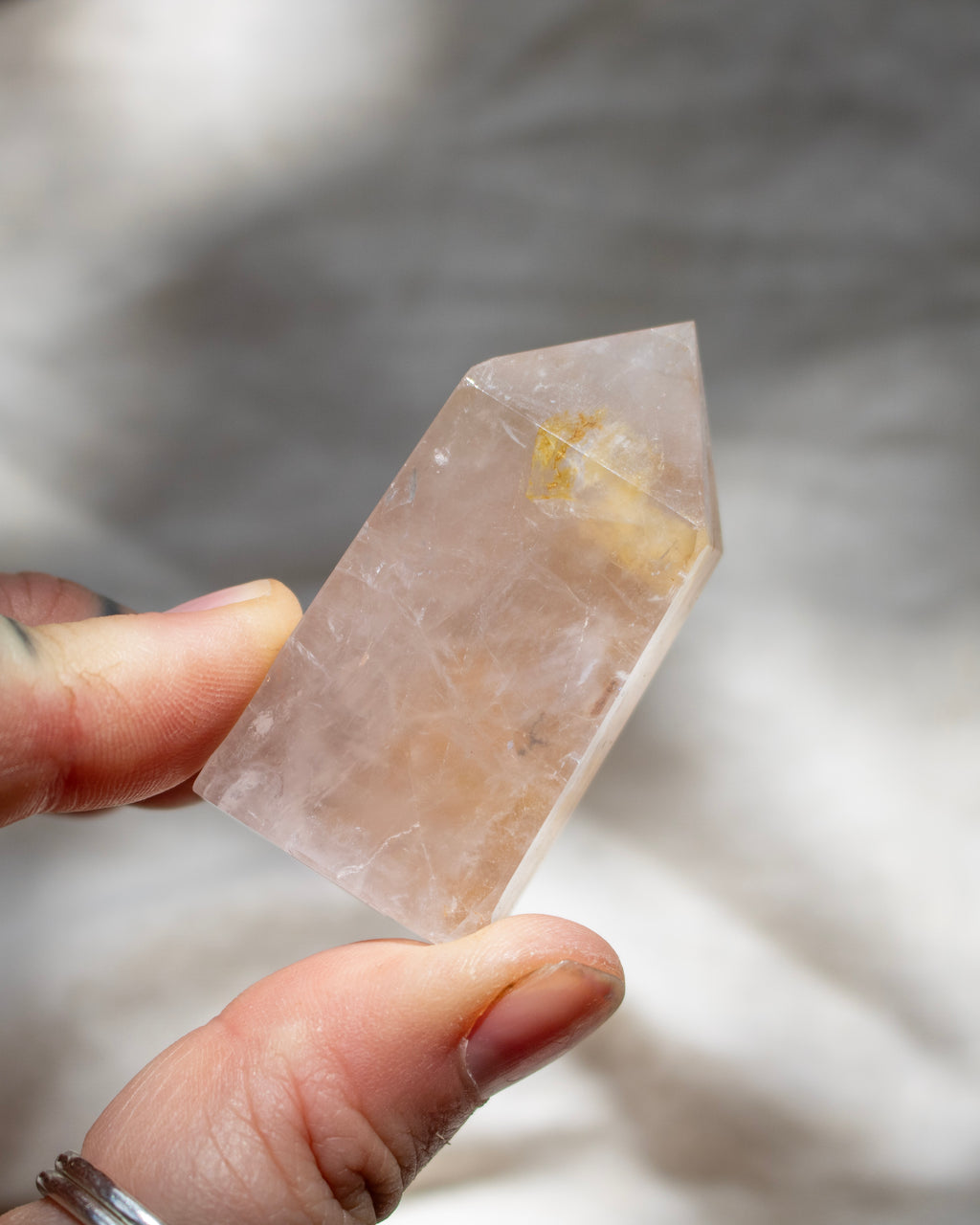 Person holding a crystal with a blurred background