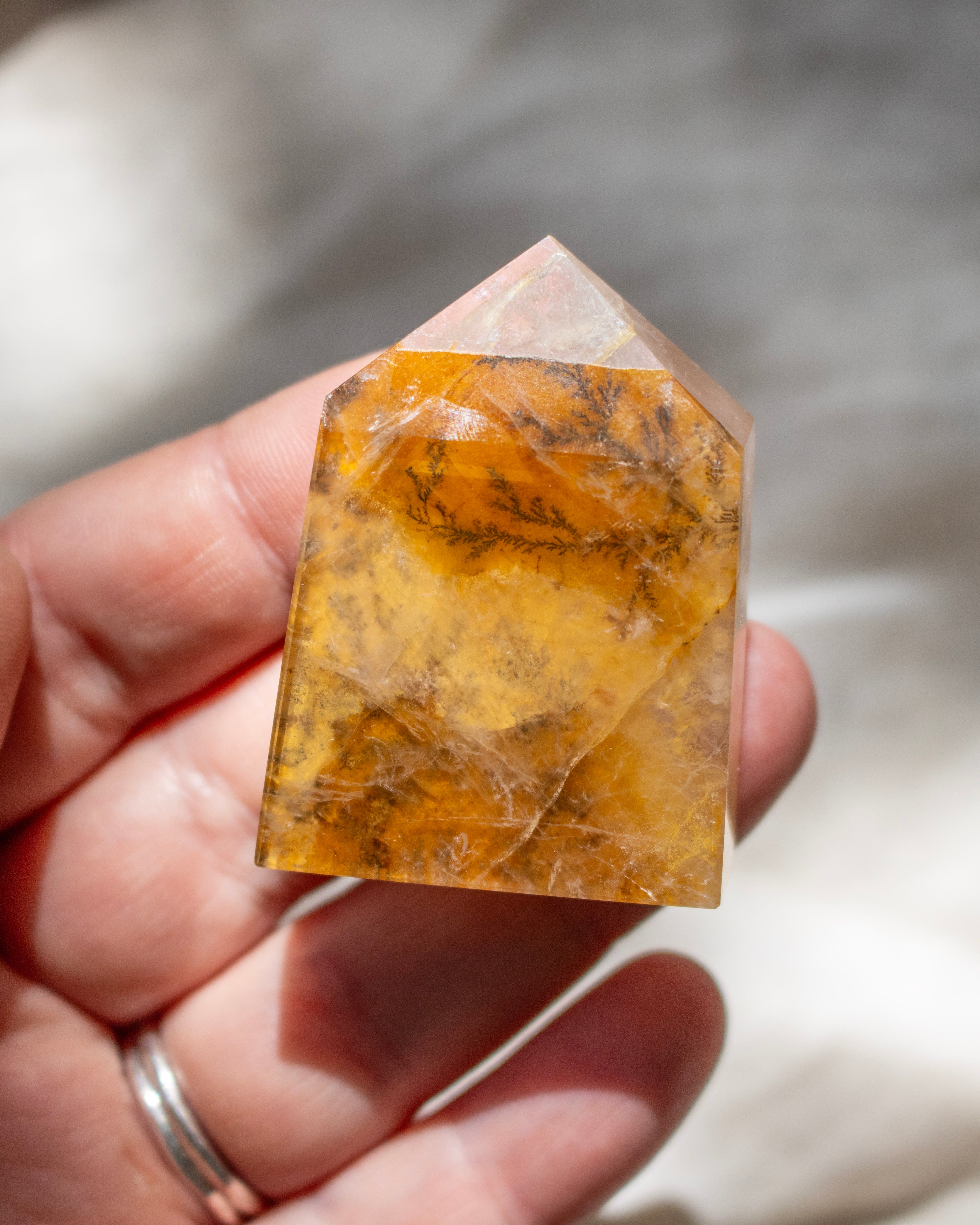 Crystal held in a hand with a blurred background