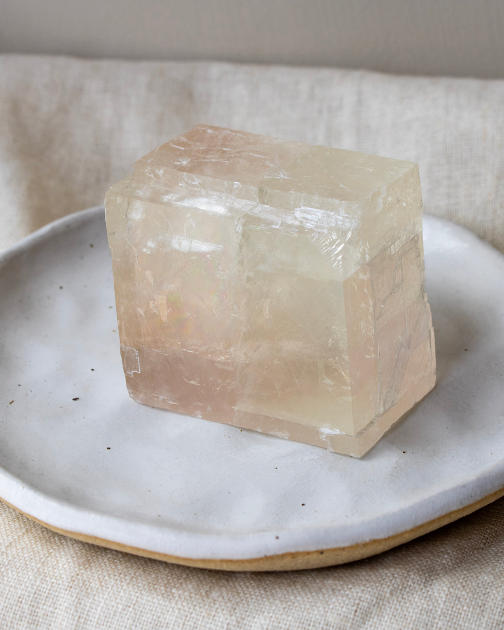 Crystal block on a ceramic plate with a neutral background