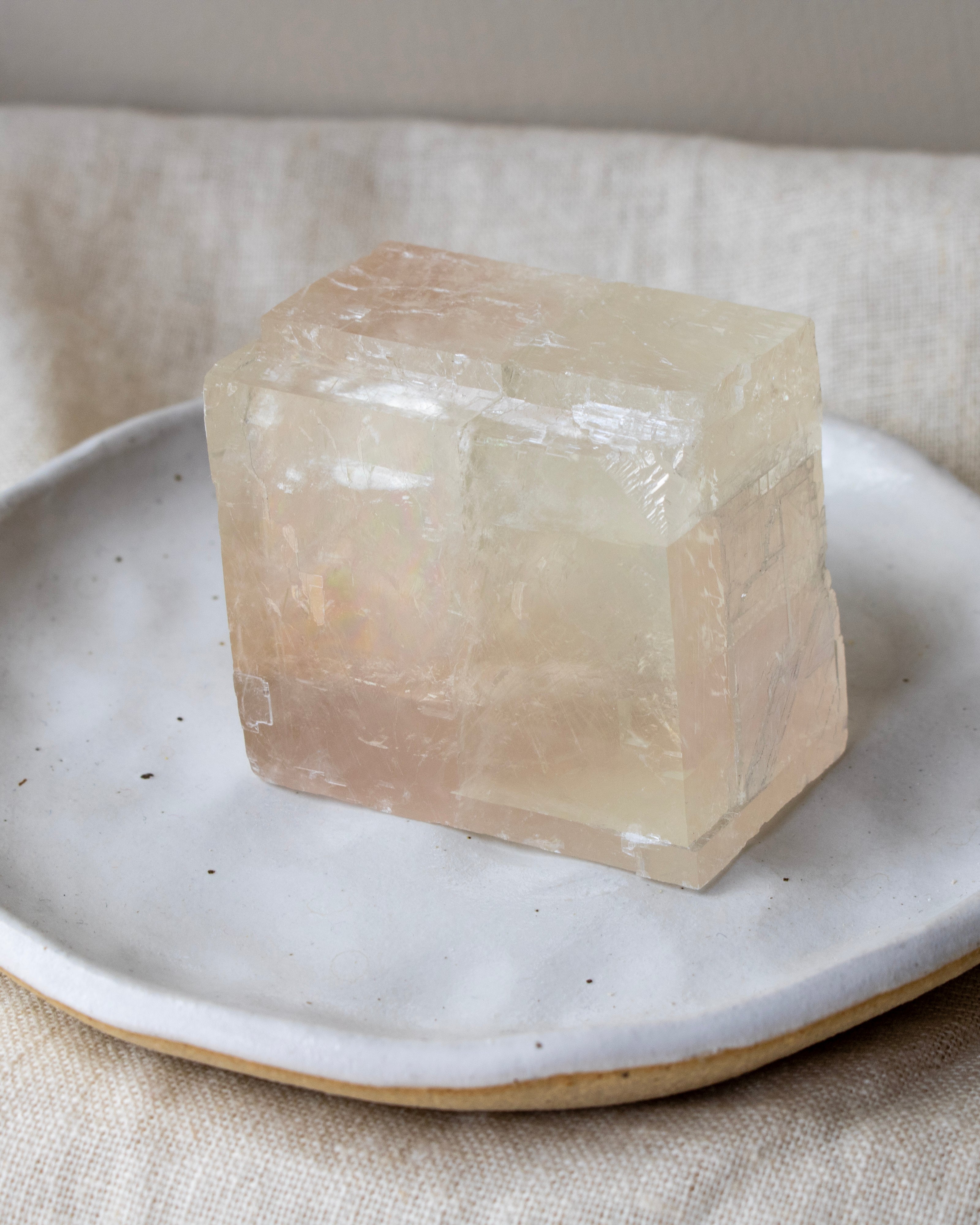 Crystal block on a ceramic plate with a neutral background