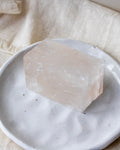 Crystal block on a white plate with a beige fabric background