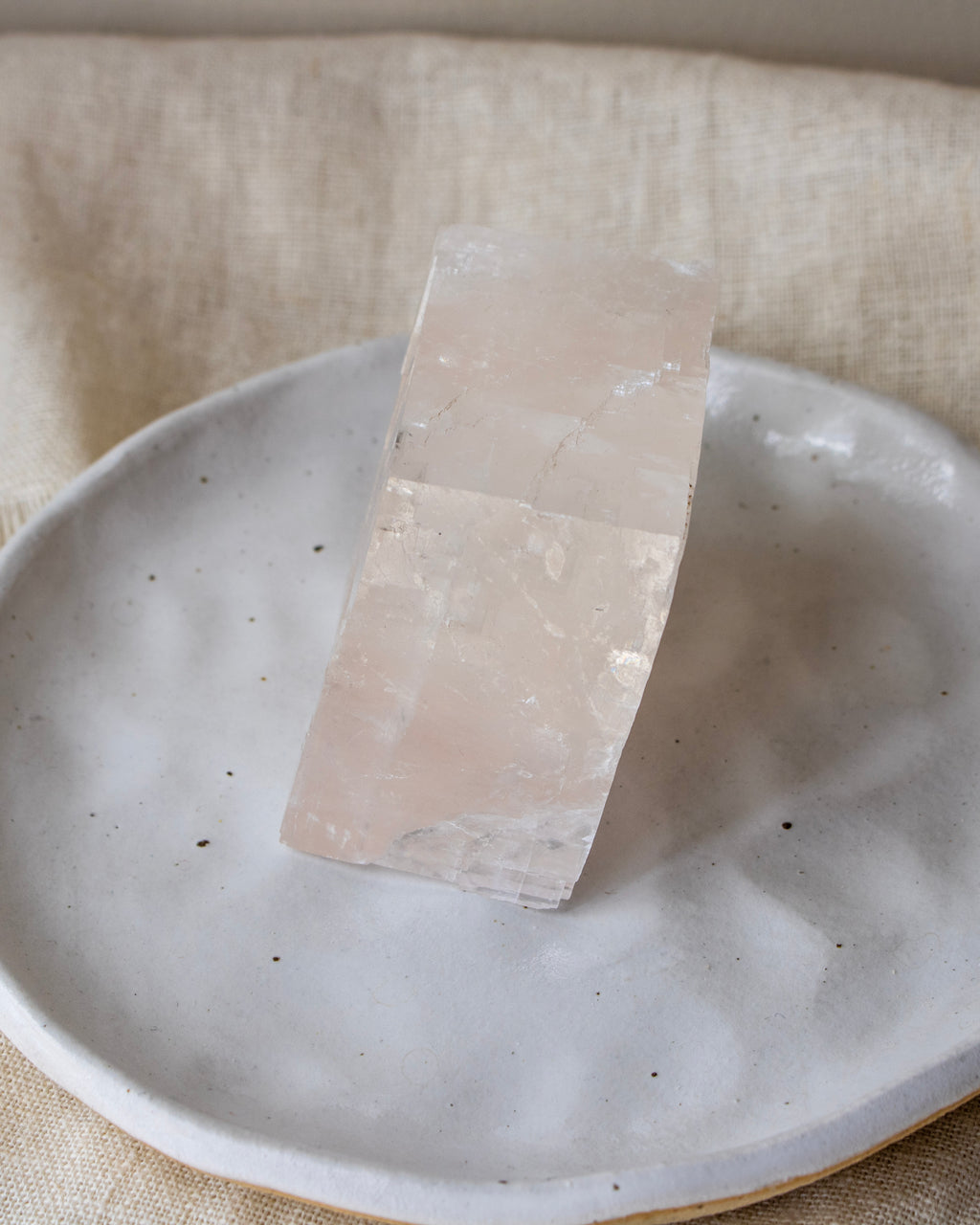Crystal on a ceramic plate with a neutral background