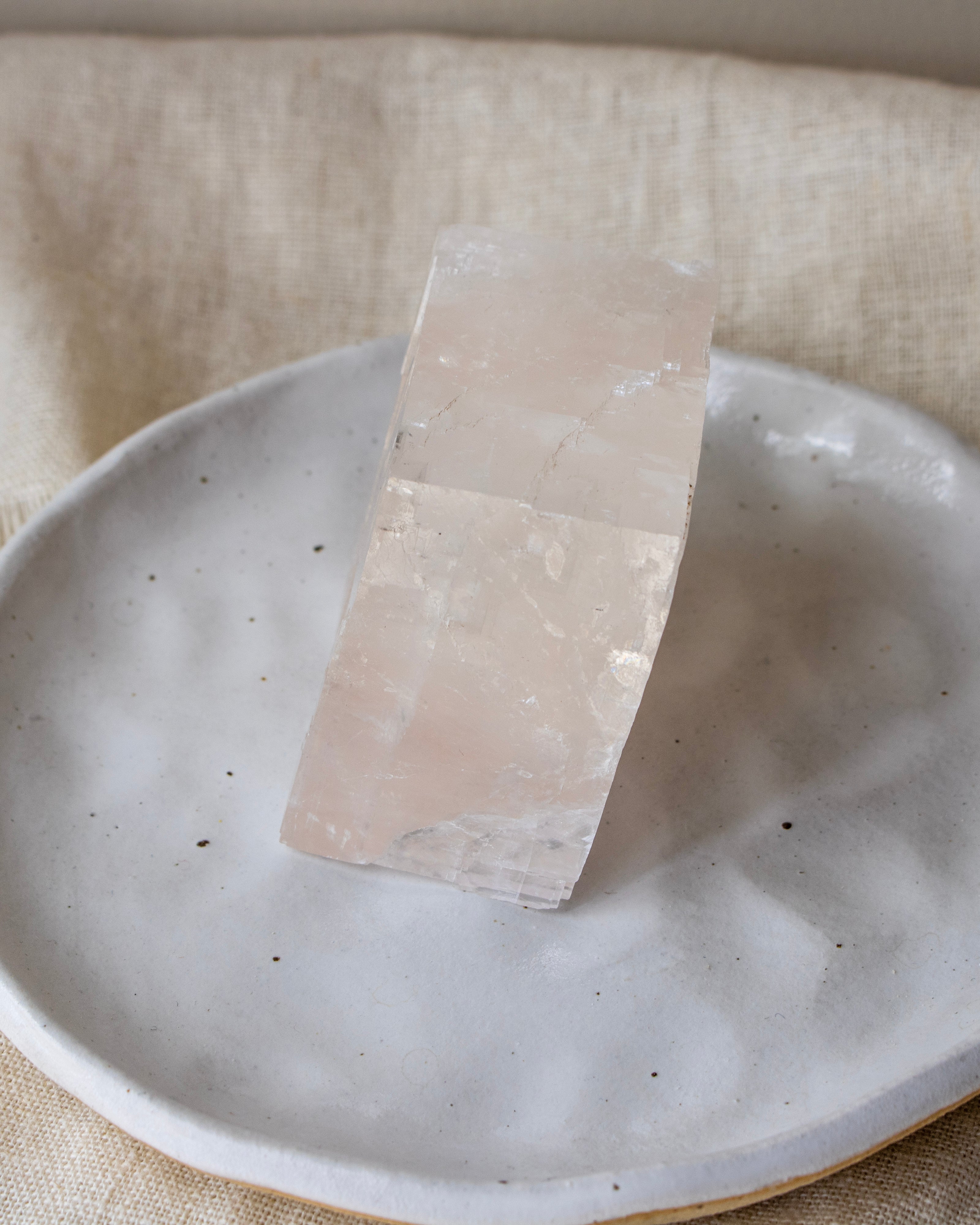 Crystal on a ceramic plate with a neutral background