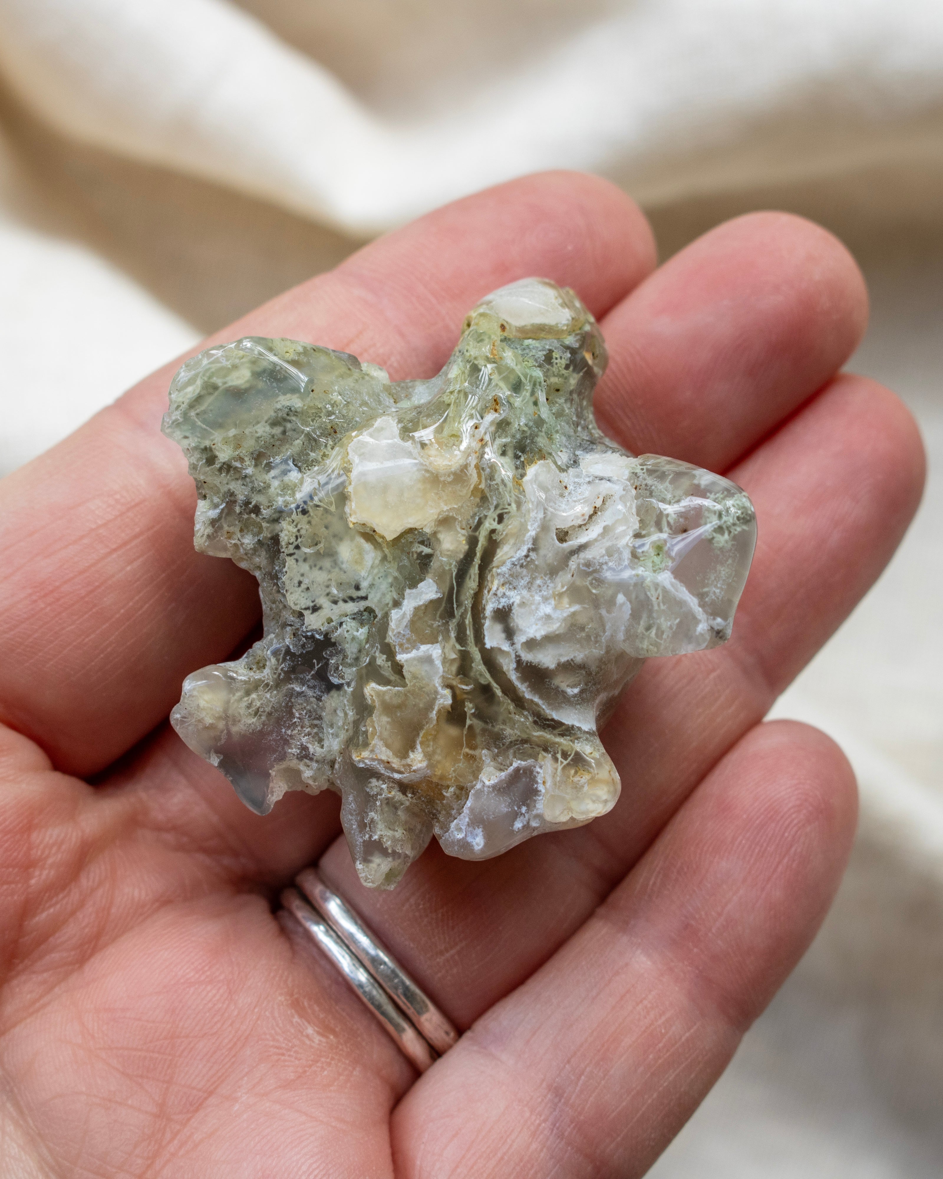 Mineral sample held in a hand with a blurred background