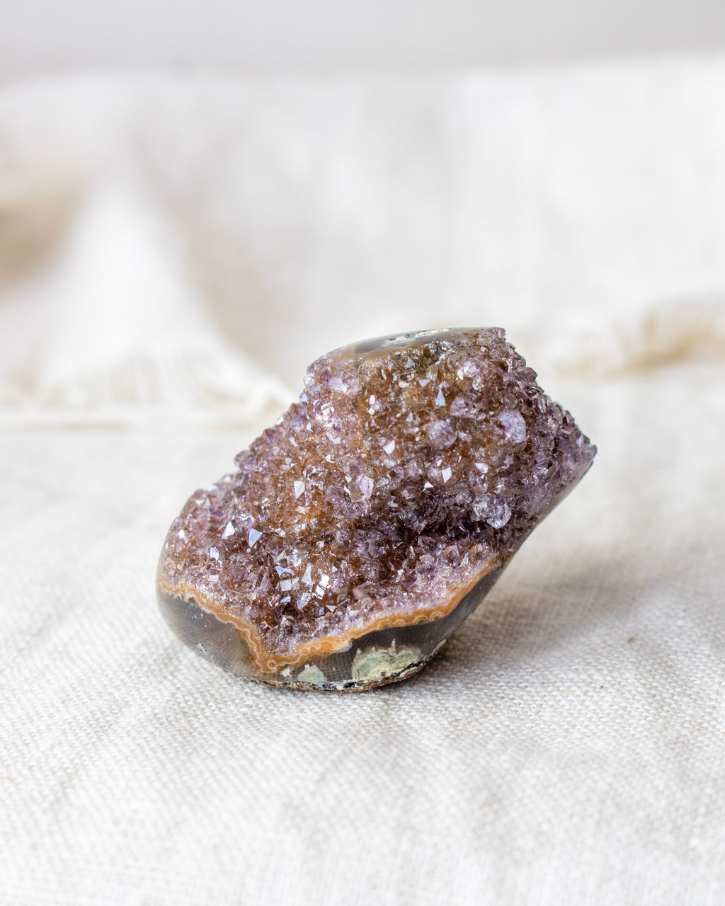 Crystal rock on a textured beige surface