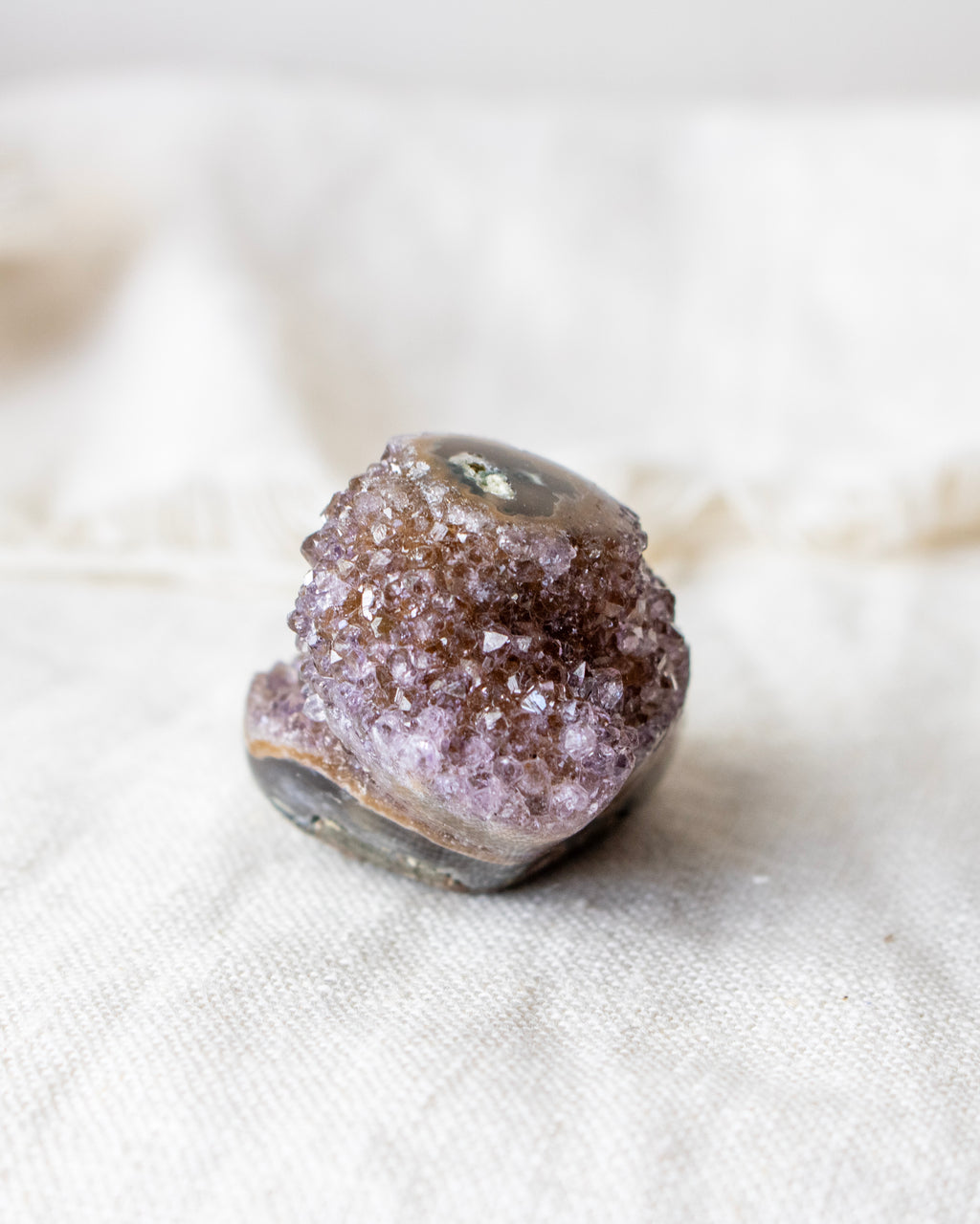 Crystal geode on a white fabric background