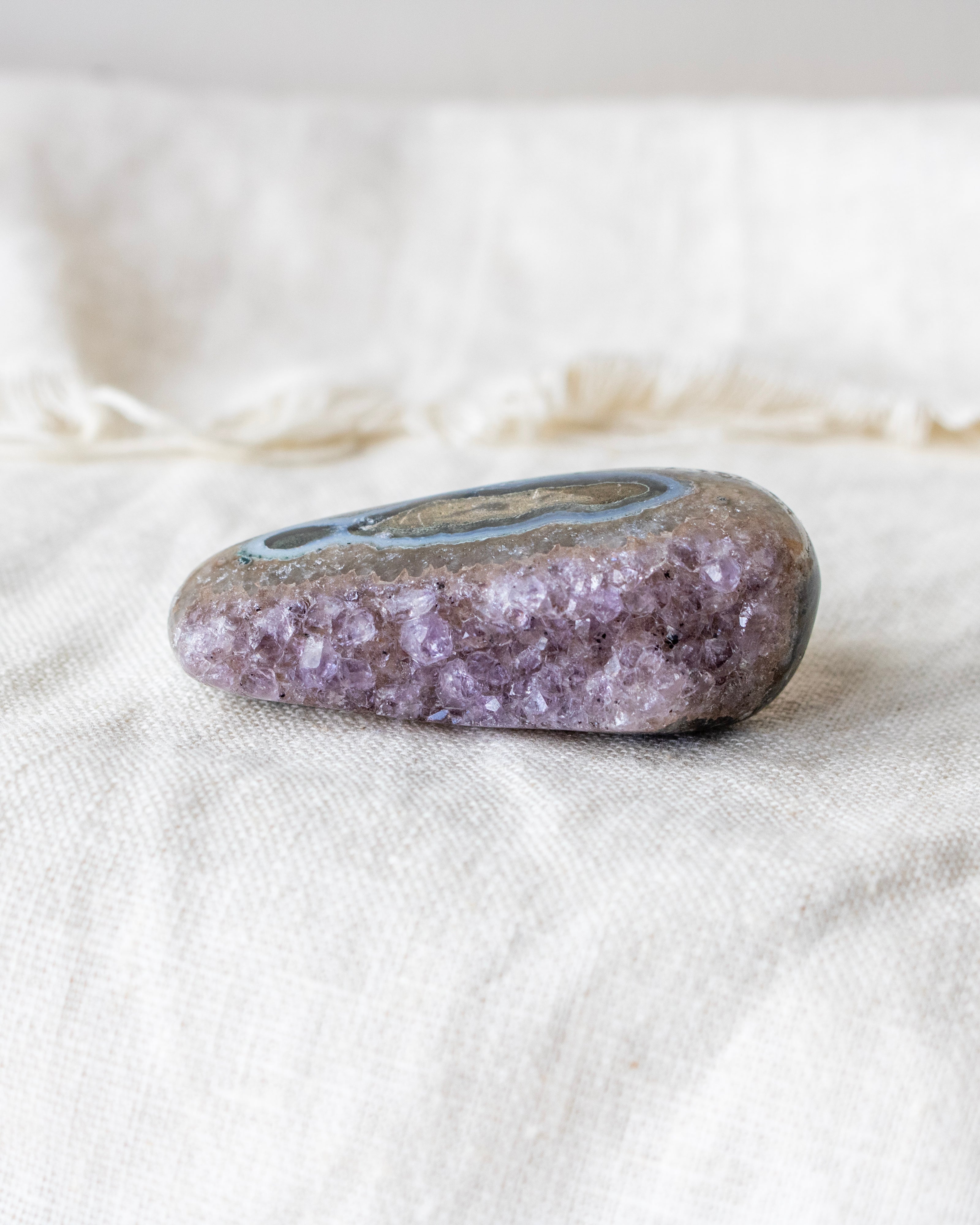 Amethyst crystal on a white fabric background
