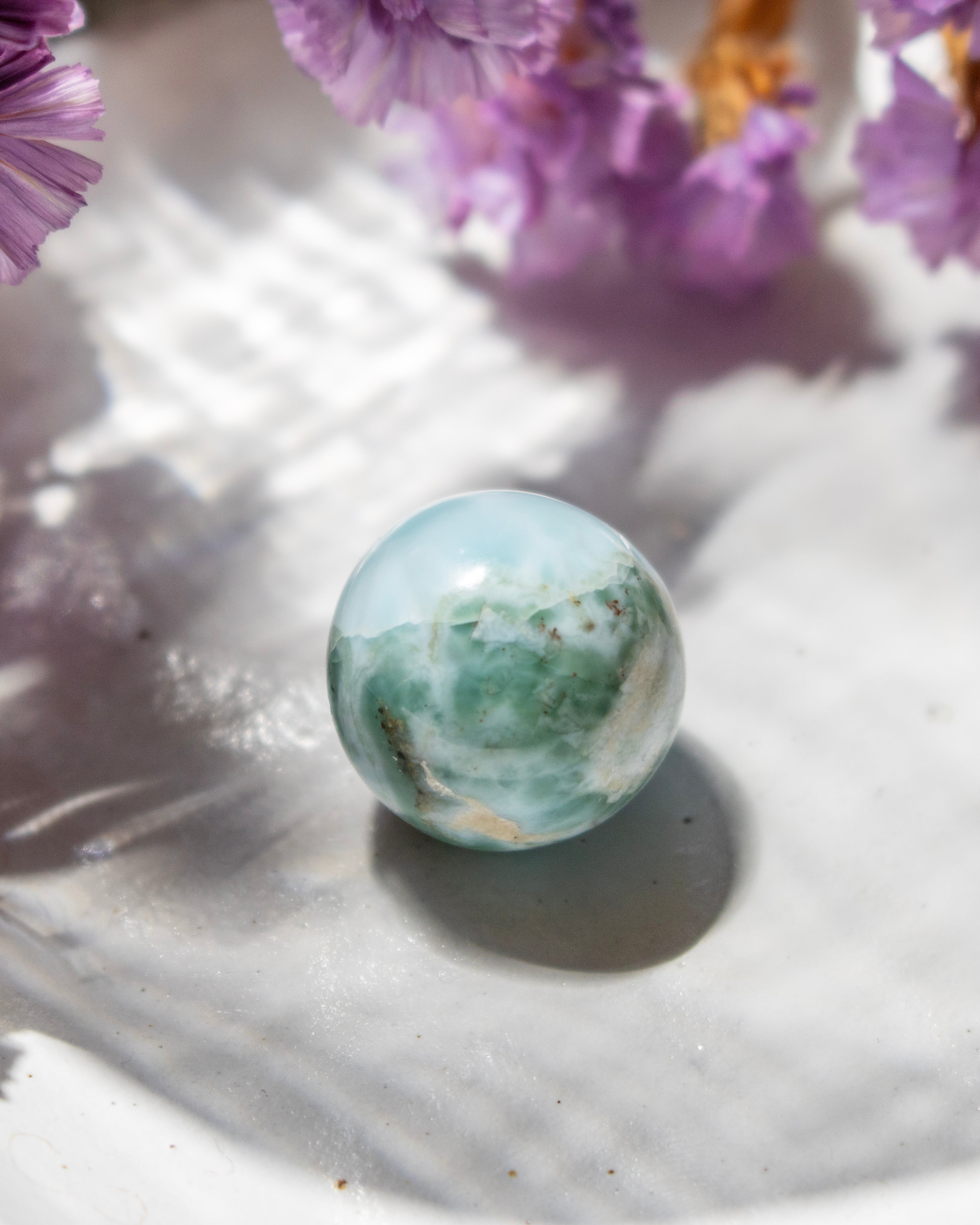 Marble-like sphere with floral background