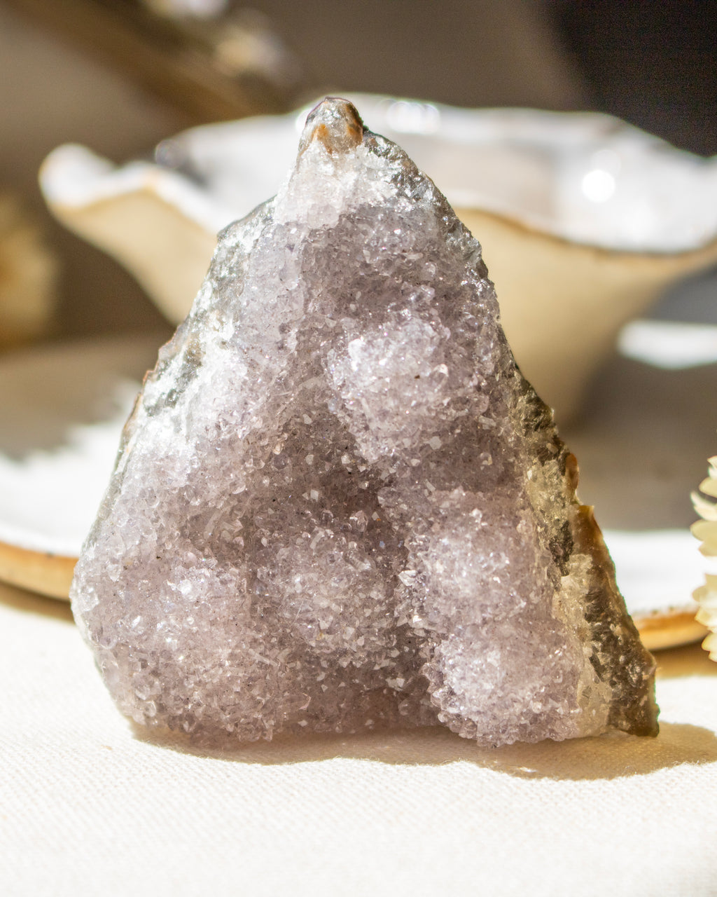 Crystal rock on a white surface with a blurred background