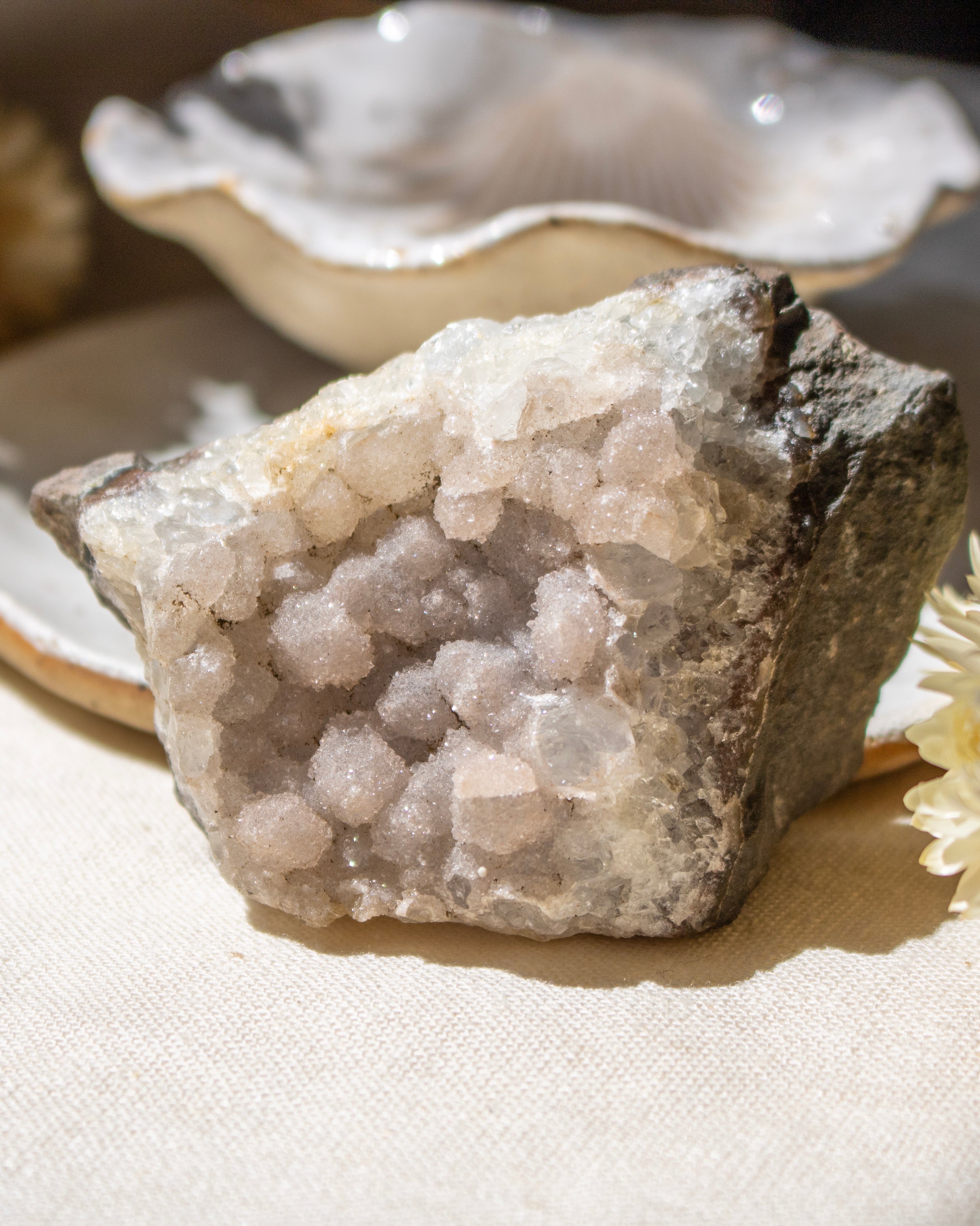 Crystal rock on a white surface with a blurred background