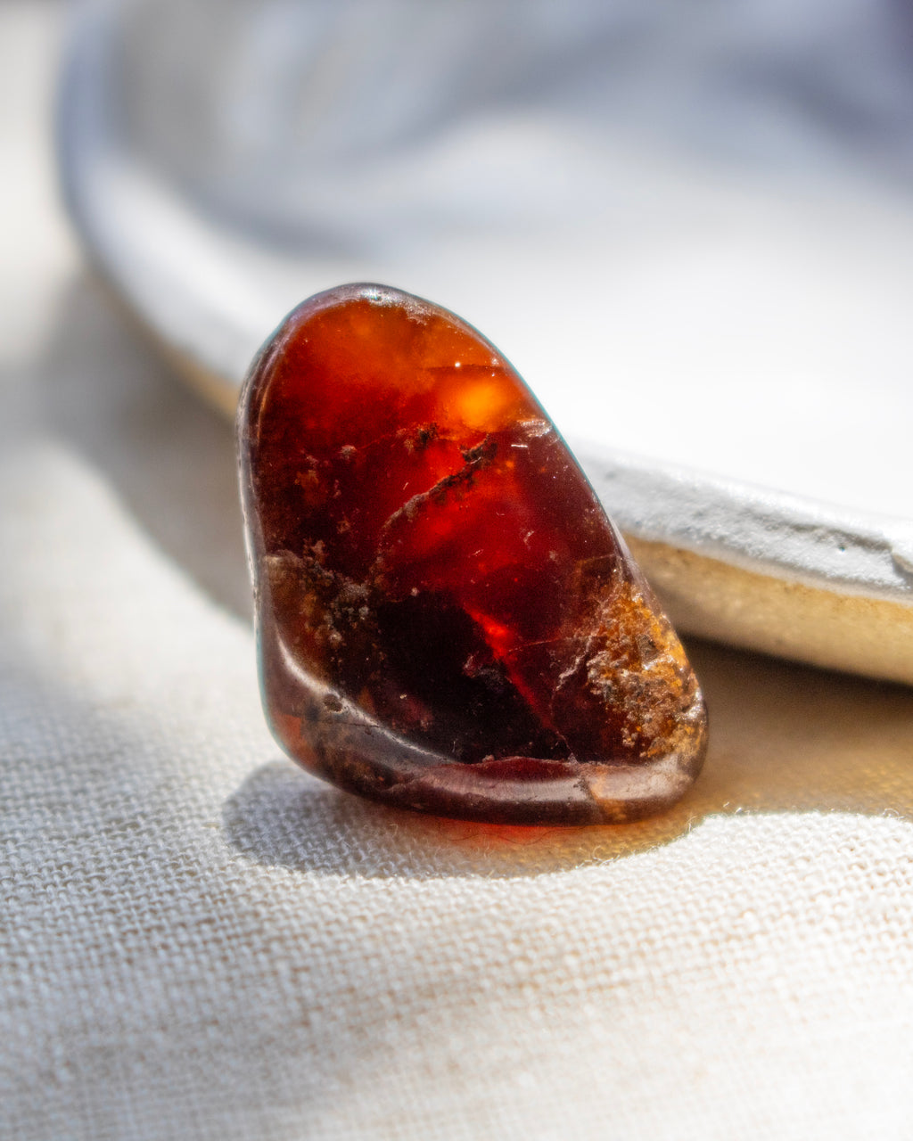 Close-up of a amber stone on a textured fabric background